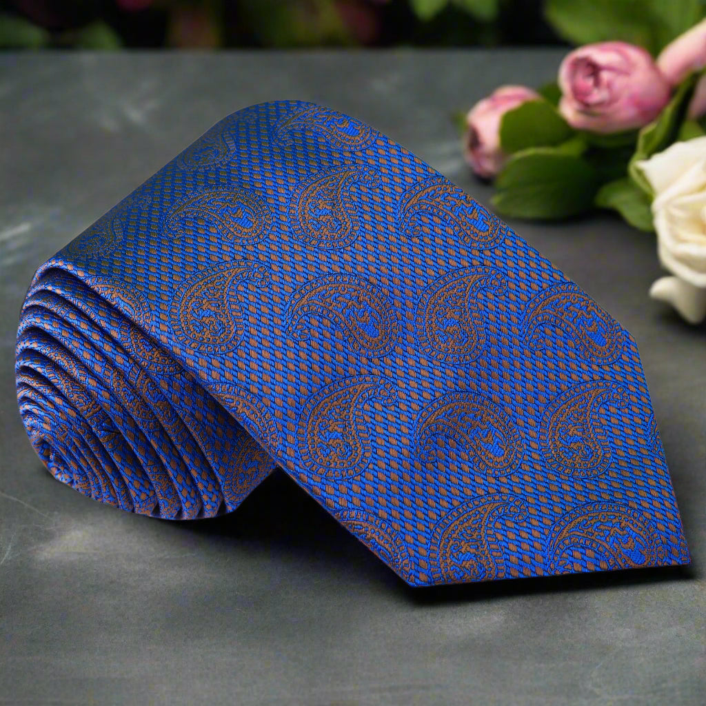 Elegant dark blue paisley silk tie displayed on a formal shirt and suit, showcasing its rich colors and patterns.