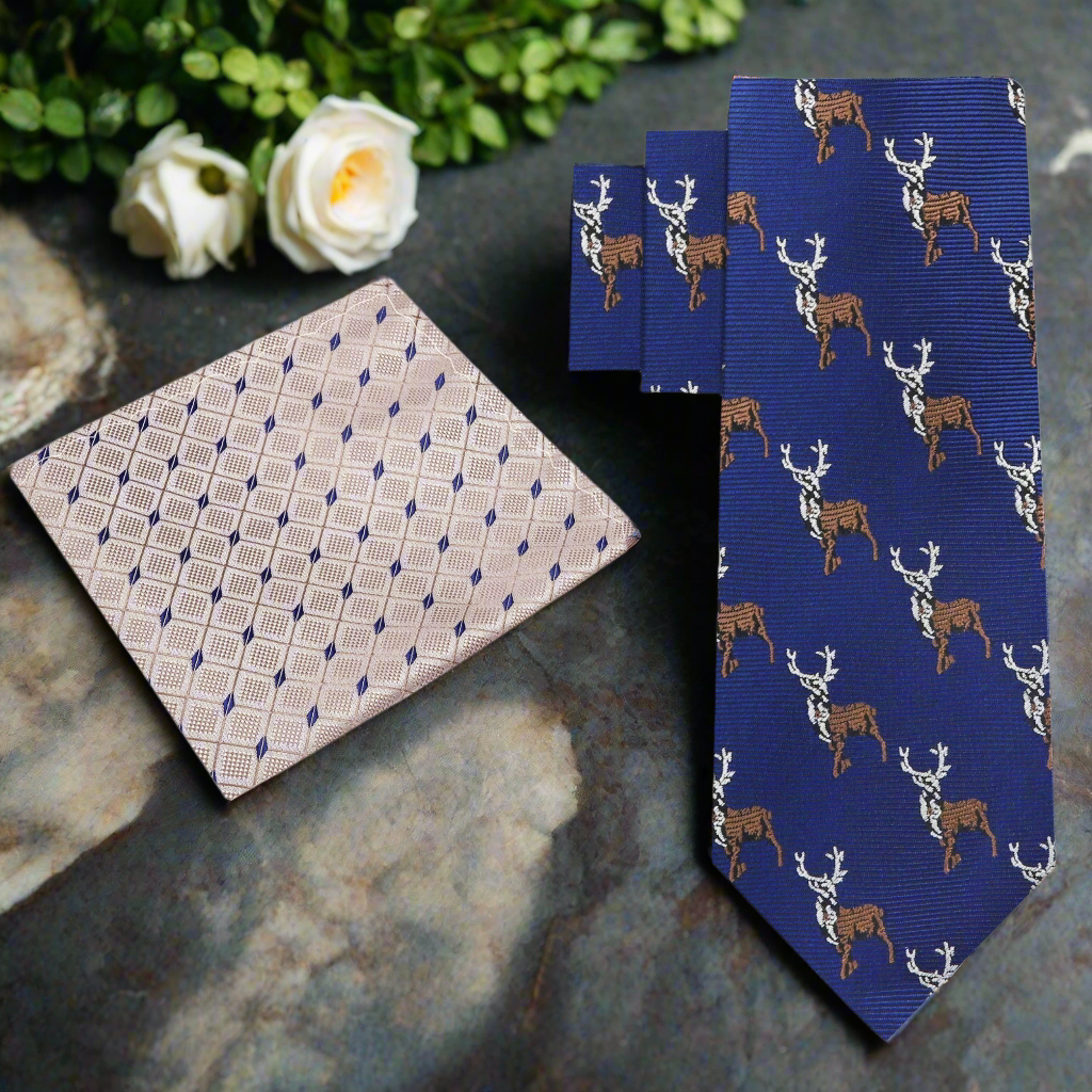 Flat lay of the silk tie alongside a solid blue pocket square and a crisp white dress shirt.