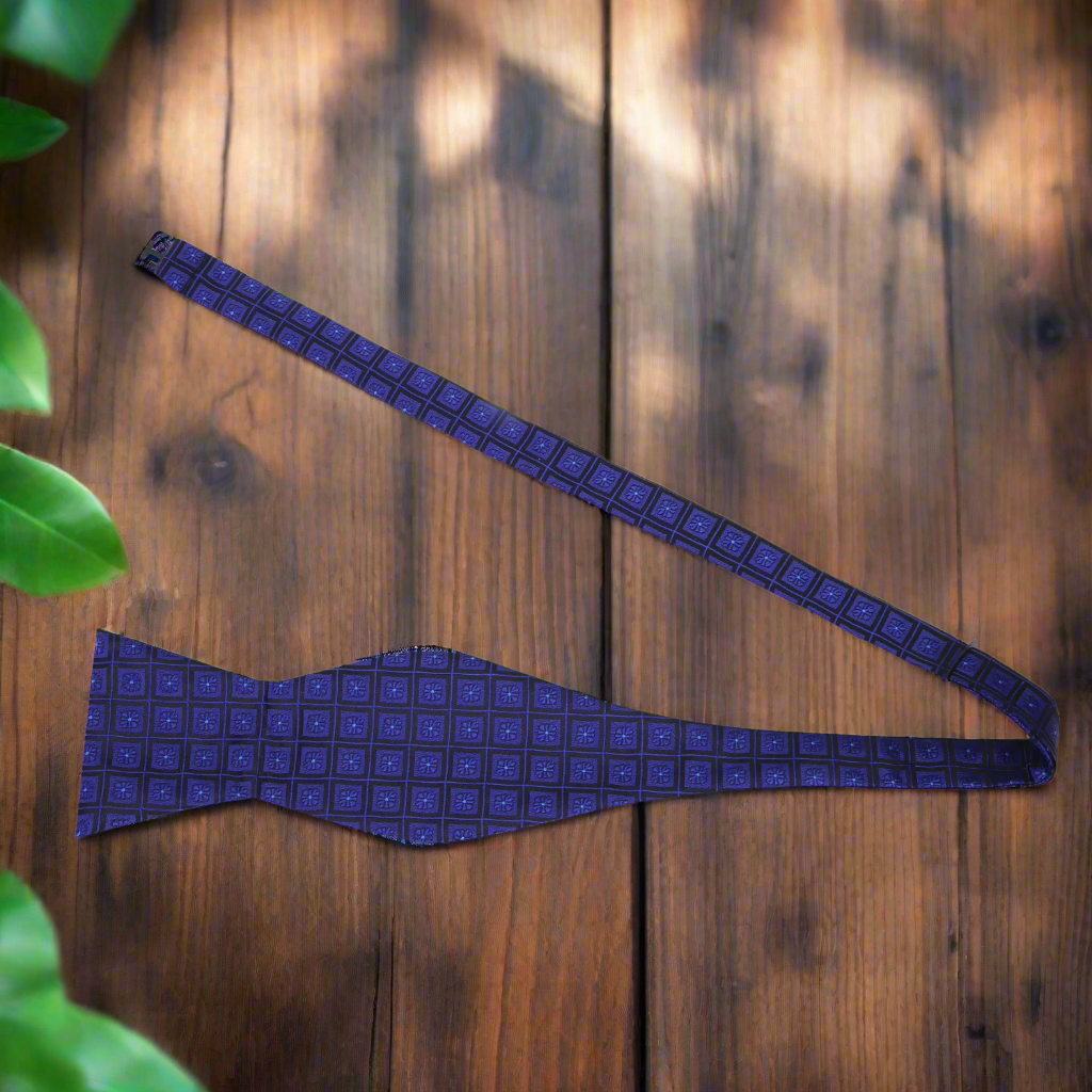 Elegant geometric patterned bow tie paired with a navy suit for a corporate event