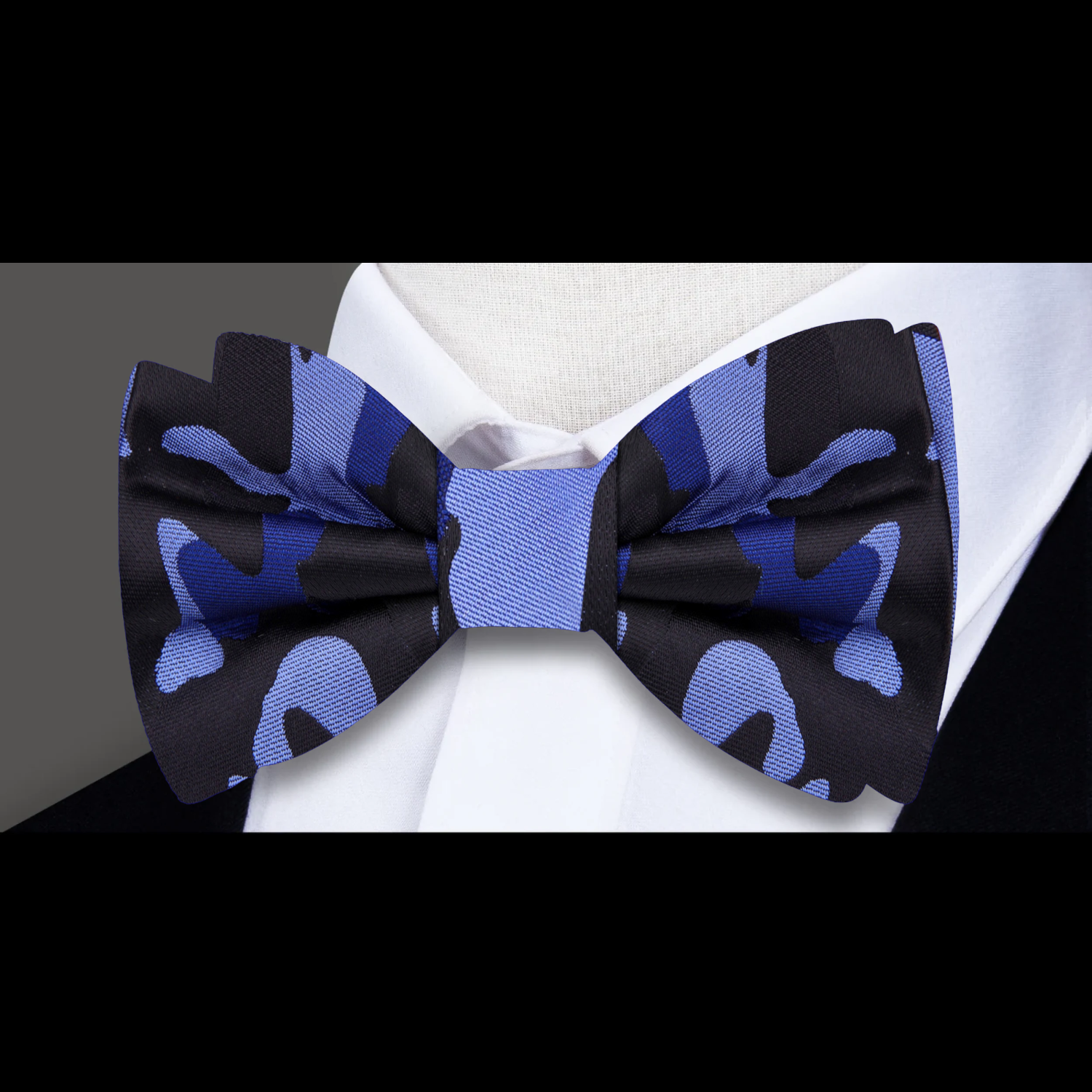 Casual outfit featuring camouflage bow tie paired with a dark blazer