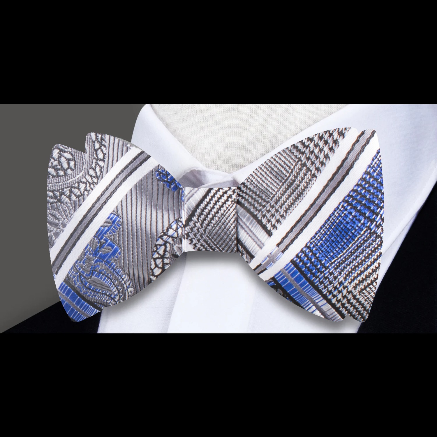 Close-up of a paisley silk bow tie with vibrant colors, perfect for weddings