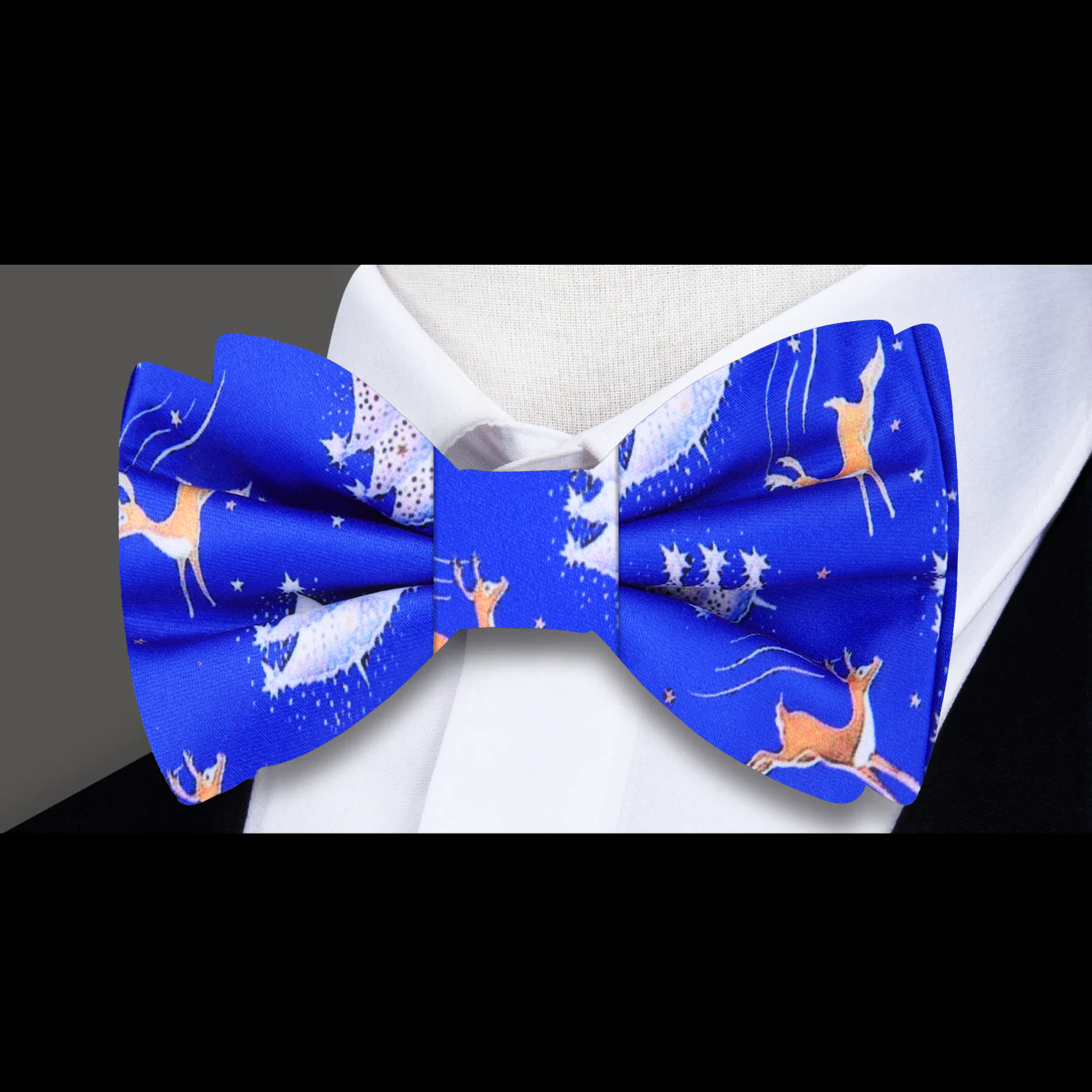 Man wearing a Christmas bow tie paired with a navy suit for holiday party