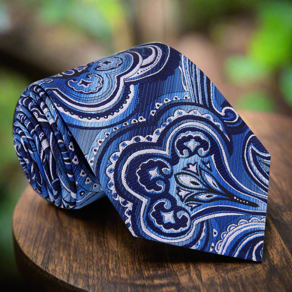 Elegant dark blue and steel grey paisley silk tie on a mannequin