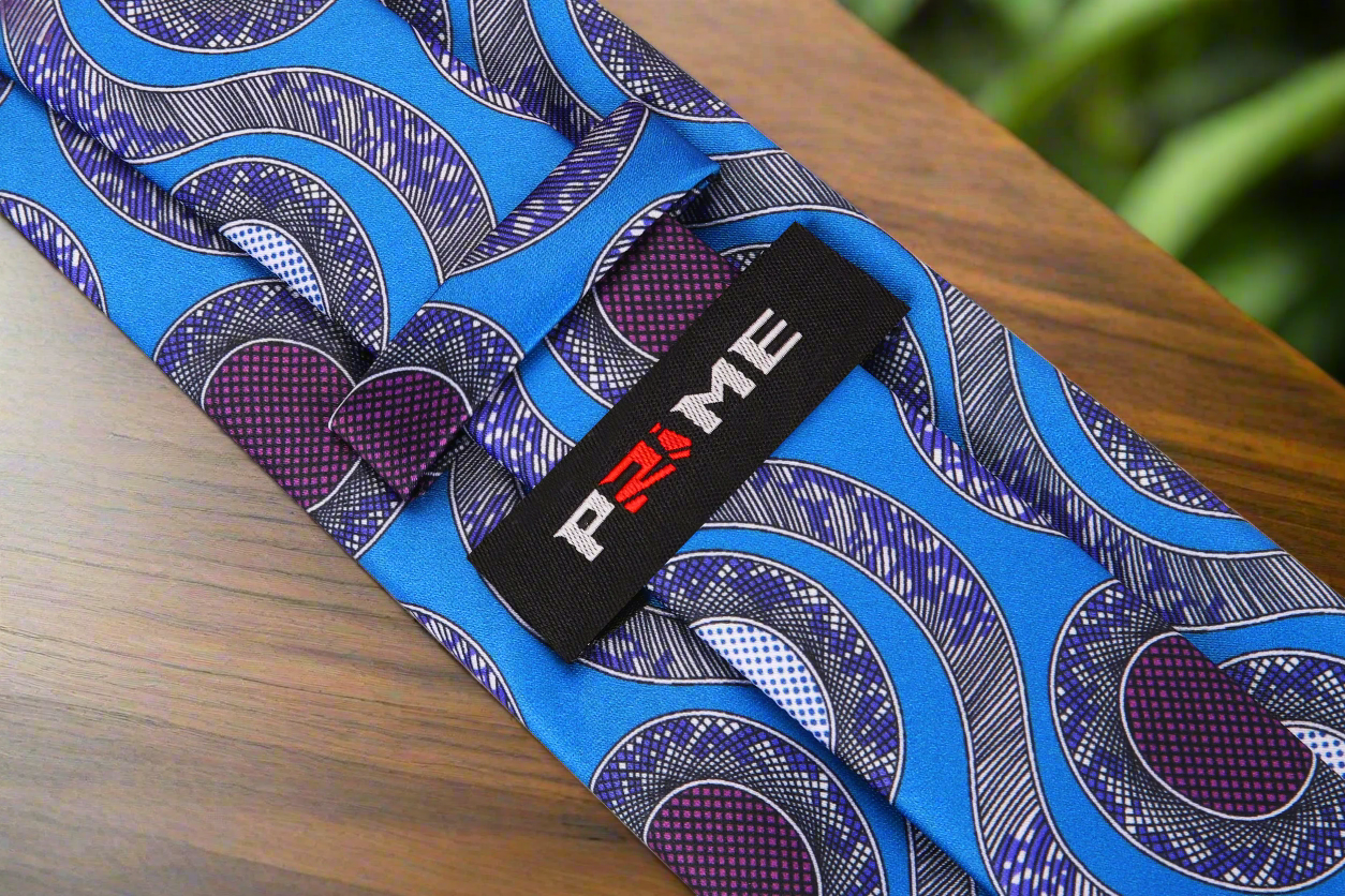 Abstract Necktie draped over a charcoal grey suit, highlighting its unique design.