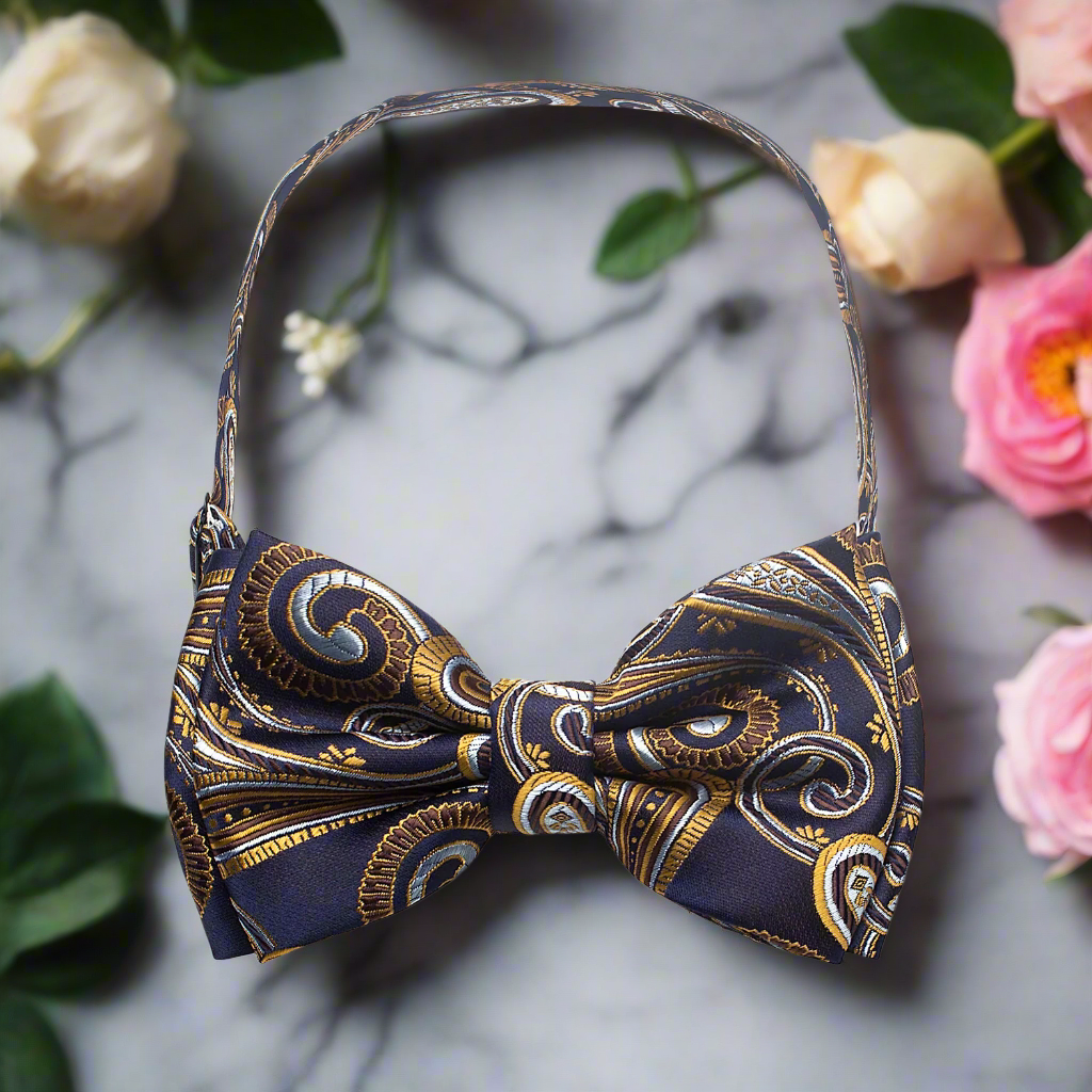 Dark blue paisley bow tie displayed with a matching pocket square for a complete look.