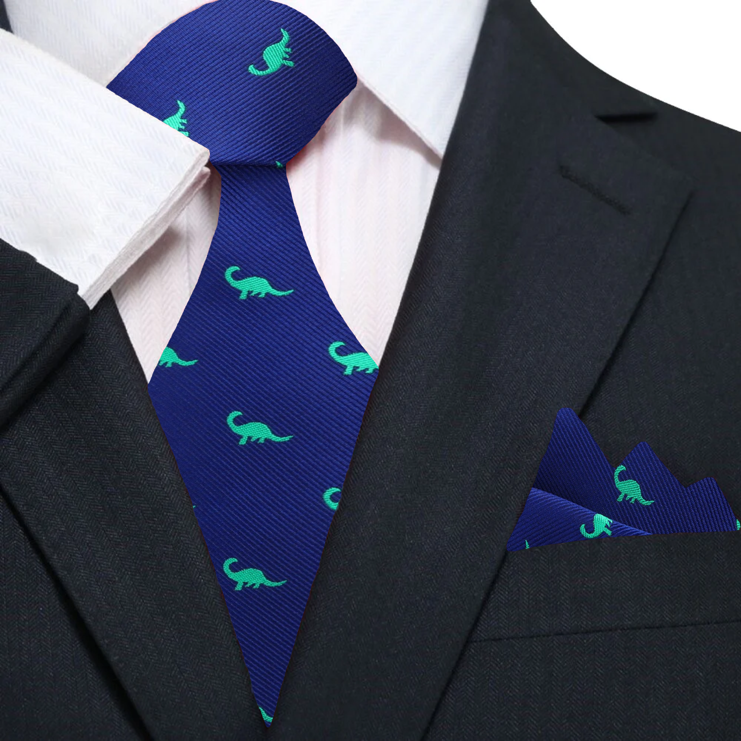 Close-up of blue silk tie with green dinosaur pattern, showcasing the detailed design.