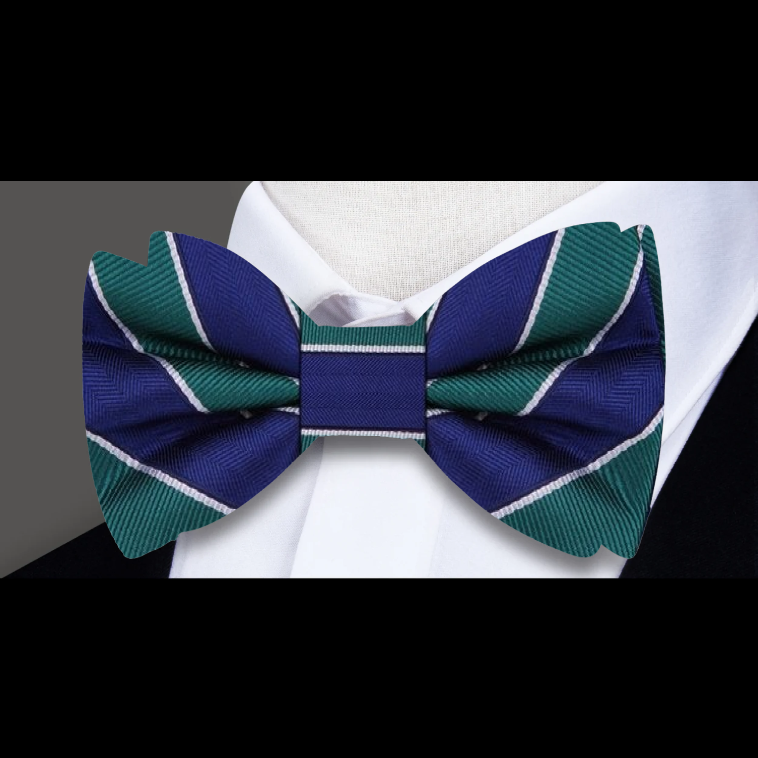 A stylish man wearing the blue and red striped bow tie at a wedding reception, exemplifying elegance.