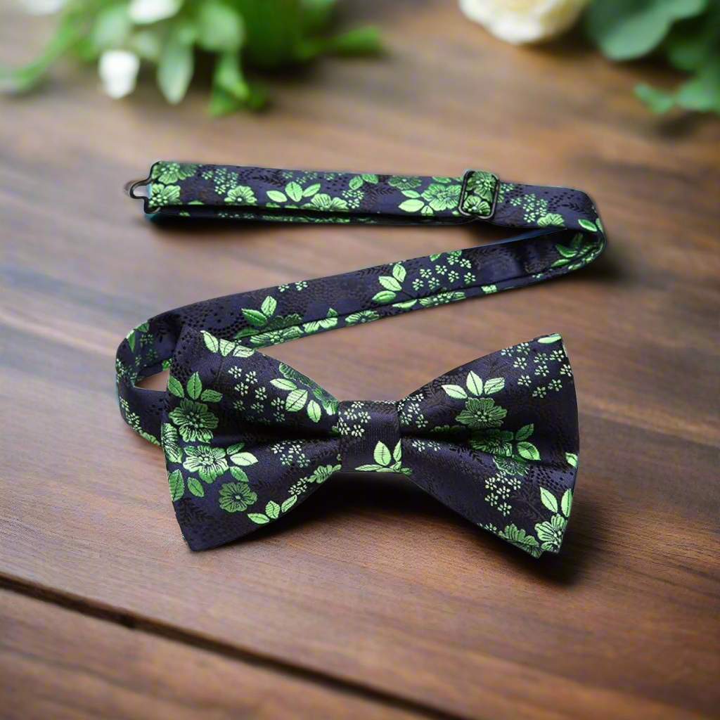 Men wearing floral bow tie with green pattern at a garden wedding