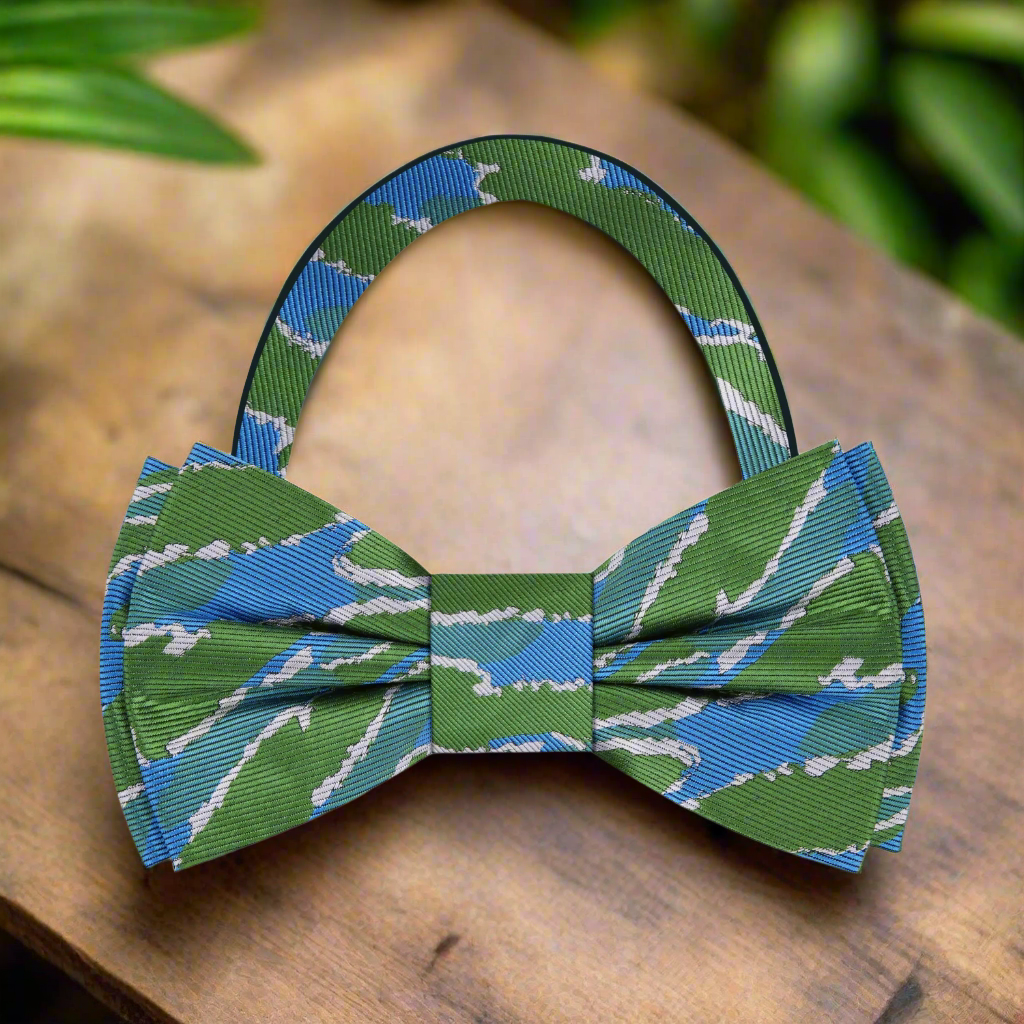Elegant silk bow tie with abstract green and blue pattern, perfect for weddings