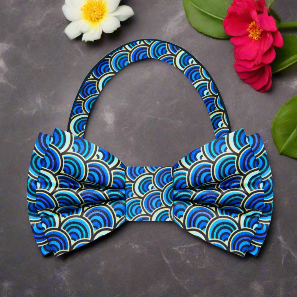 Vibrant bow tie paired with a navy blue suit, showcasing its colorful design.