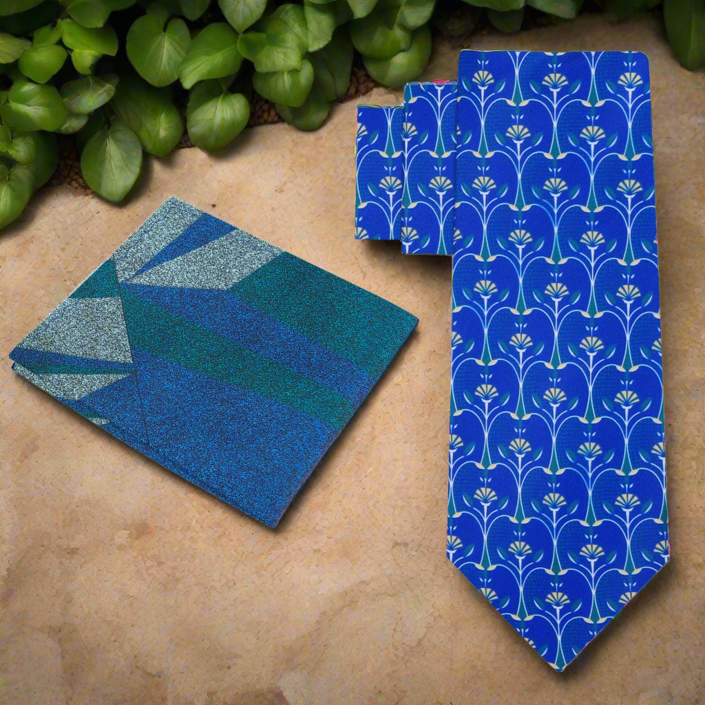 Close-up of a blue silk necktie featuring an apple slice pattern, perfect for casual office wear.
