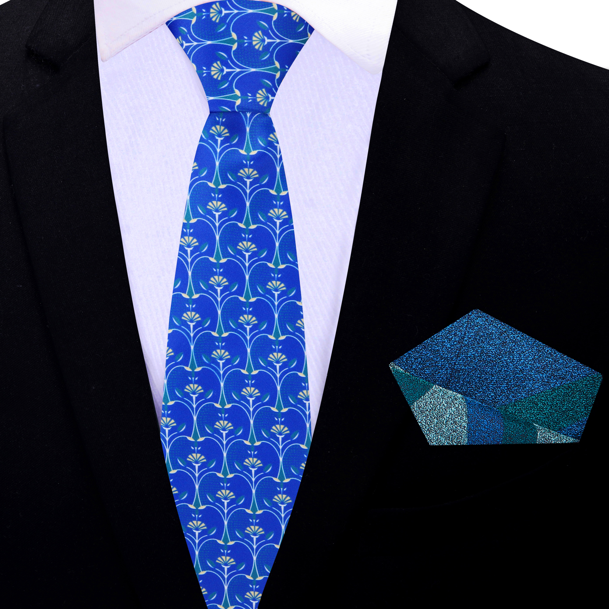 Model wearing a blue silk necktie with apple slice pattern paired with a light grey suit.