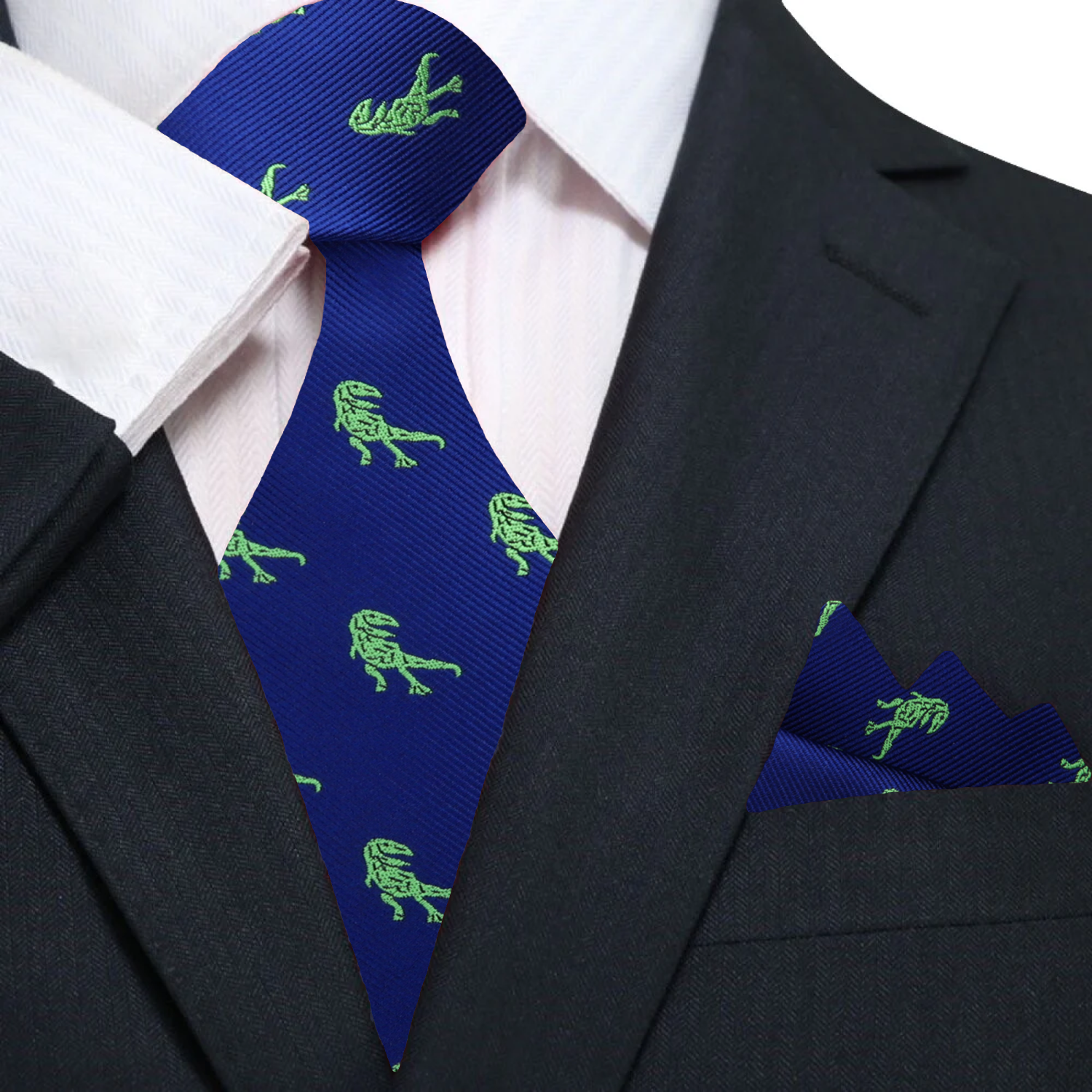 Full view of the unique dinosaur print tie paired with a light grey suit and white shirt.