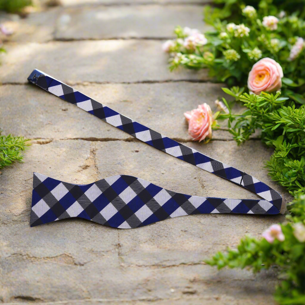 Close-up view of the yellow and blue plaid pattern in a silk bow tie.