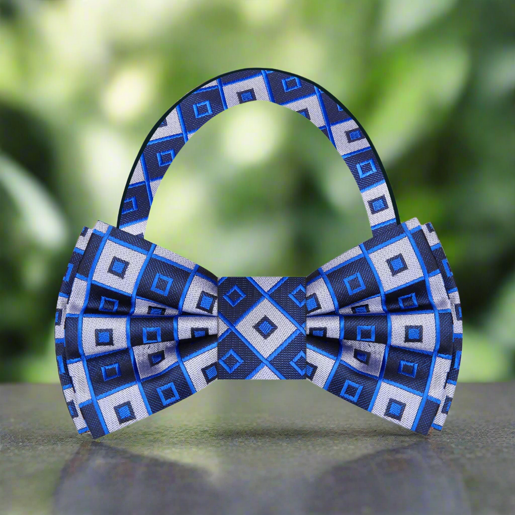 Geometric bow tie displayed against a white background showcasing its navy blue, black, and silver colors.