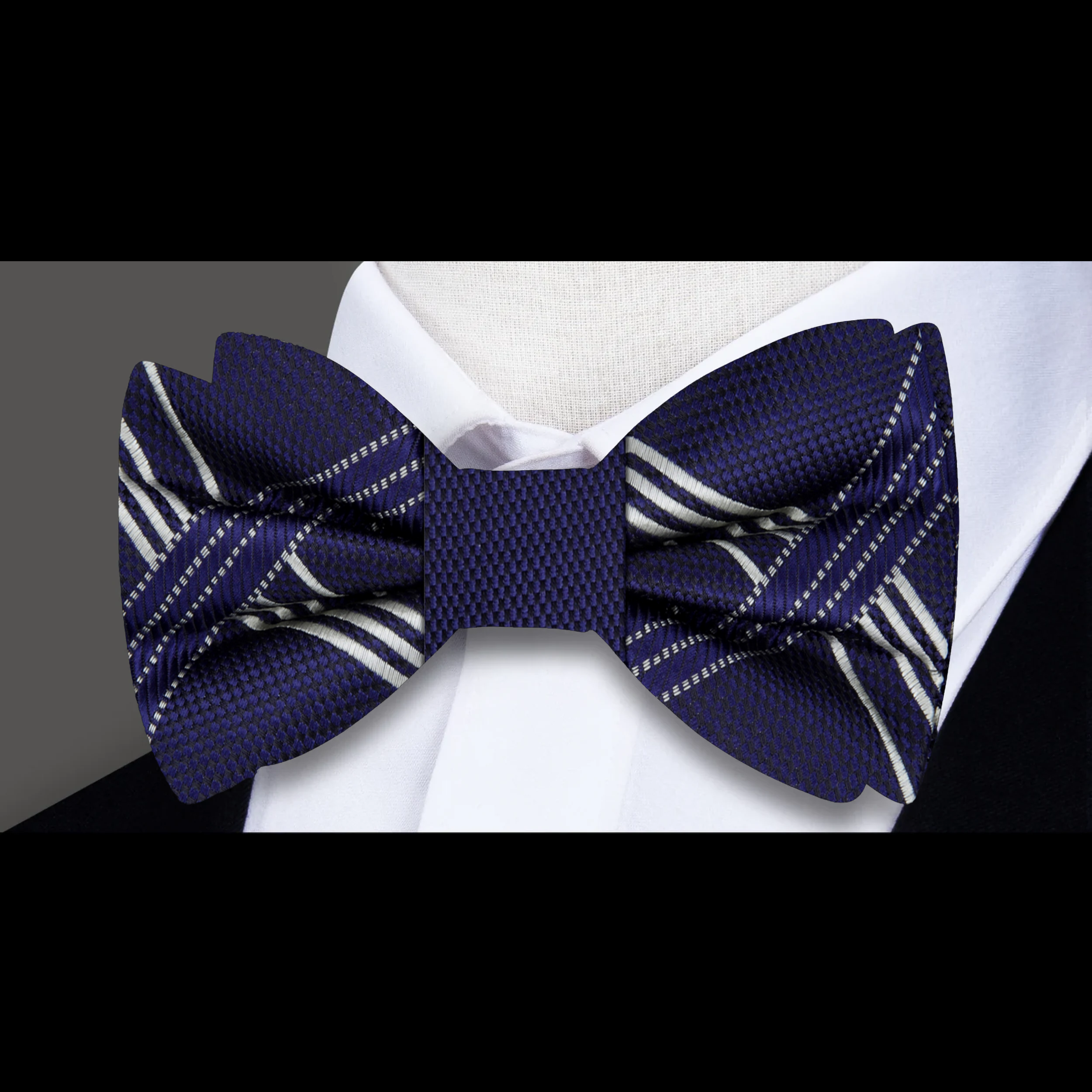 Man wearing a stylish plaid bow tie with a white dress shirt for a business meeting