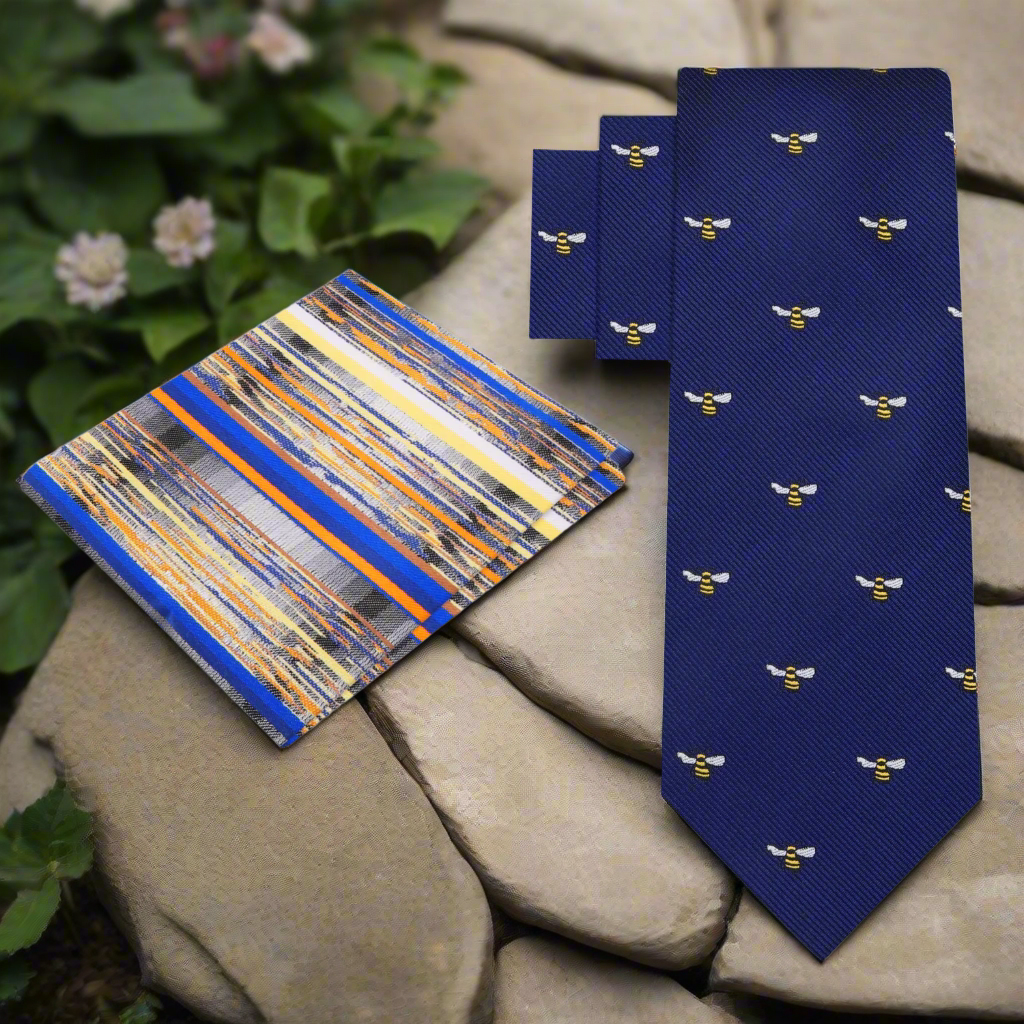 Close-up of blue silk necktie with bee pattern, perfect for wedding attire