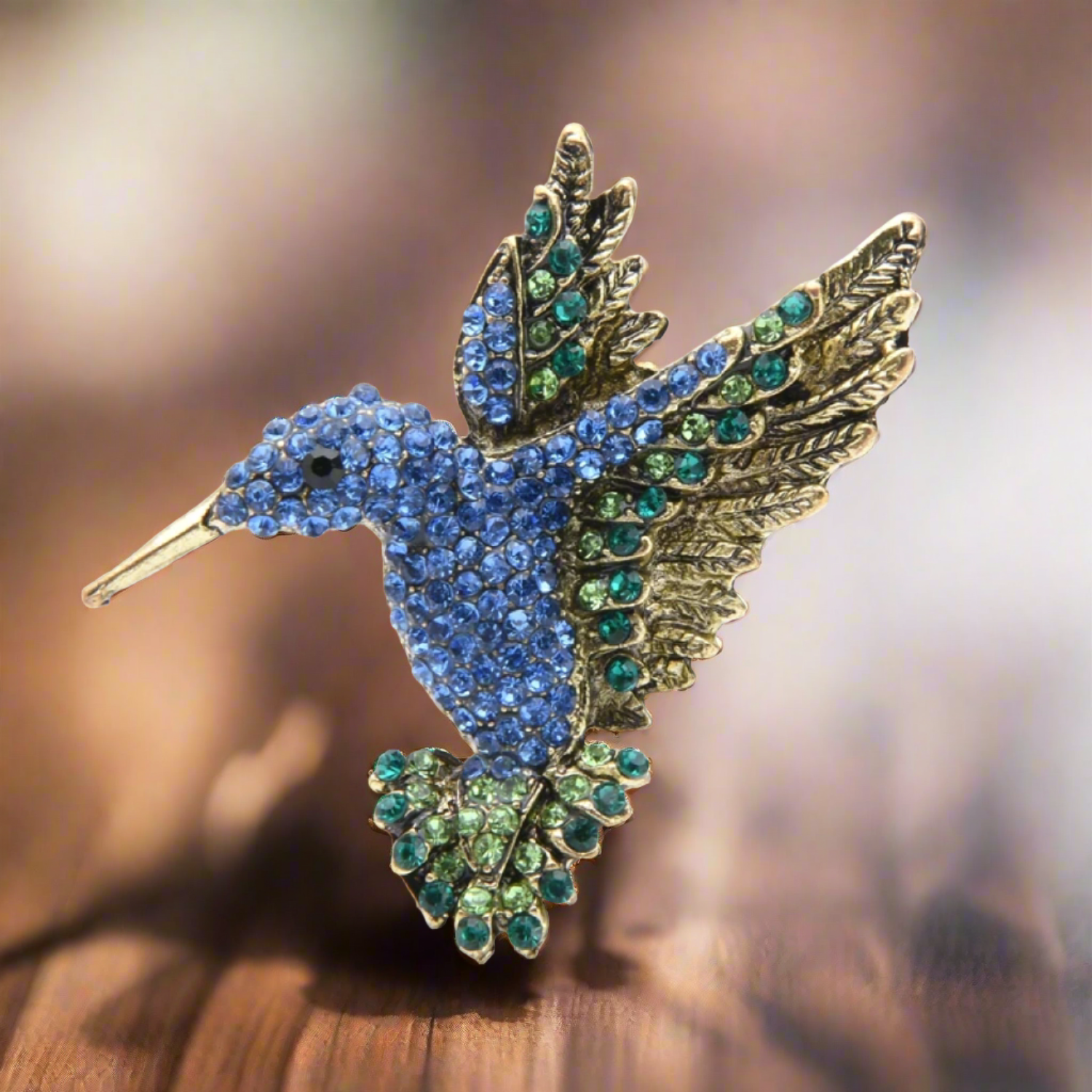 Elegant hummingbird pin displayed on a stylish blazer, enhancing the outfit with a touch of nature-inspired charm.