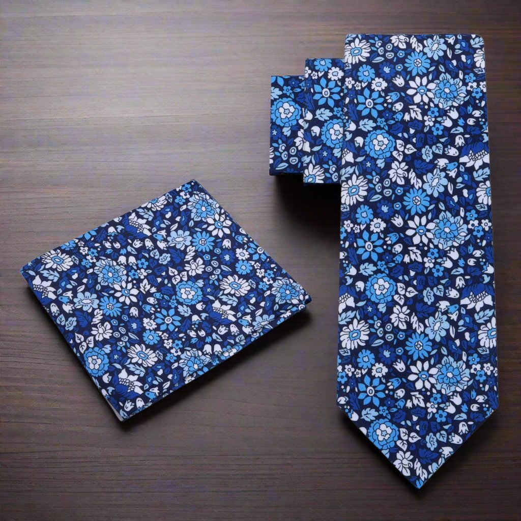 Elegant navy blue silk tie with floral pattern on a mannequin