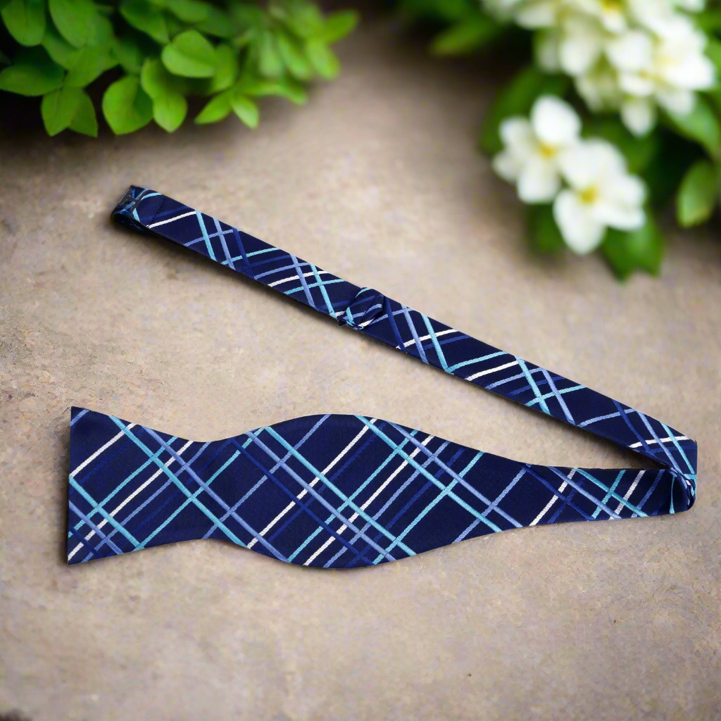 Close-up of customizable self-tie bow tie showcasing the plaid pattern and silk texture.