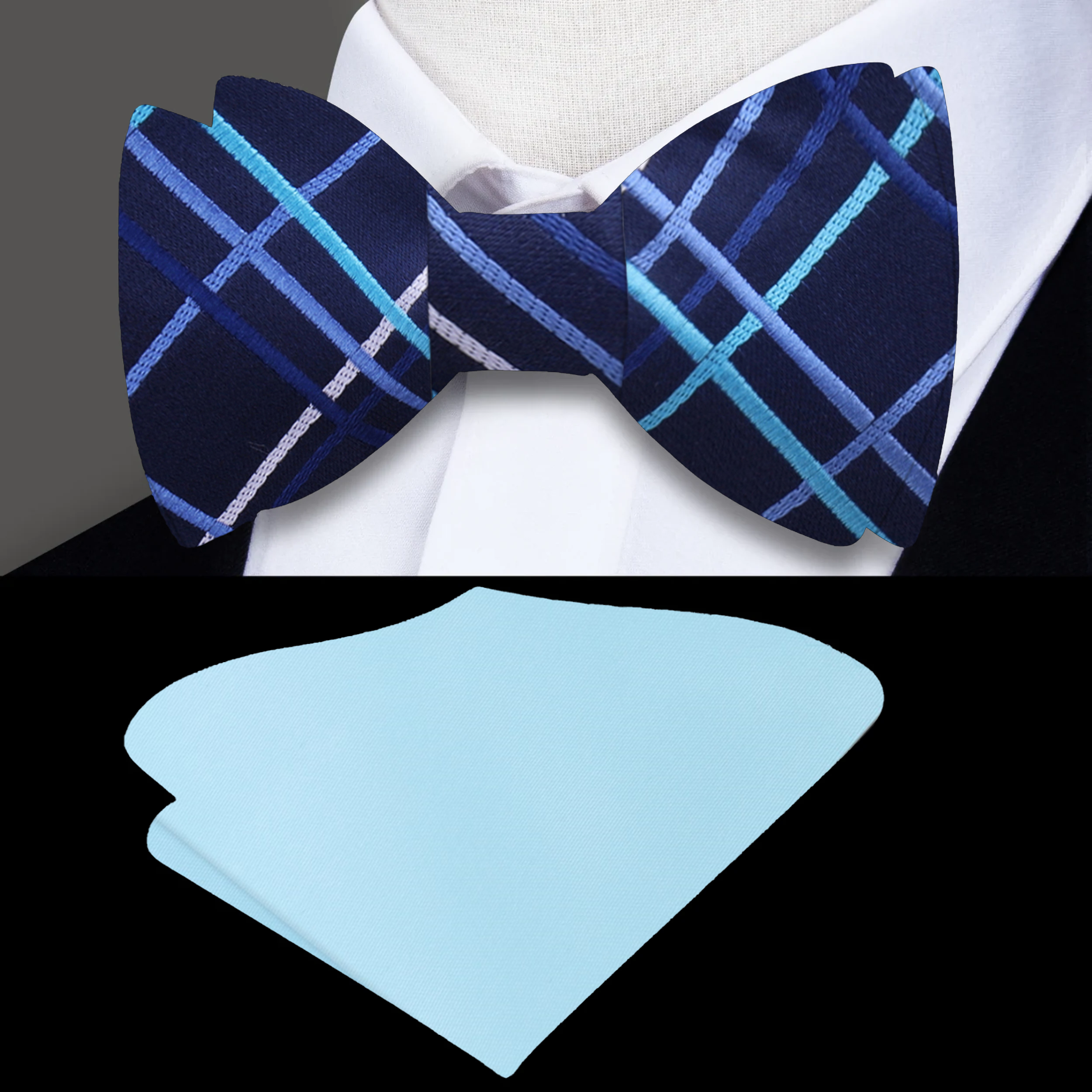 Dark blue bow tie paired with a light blue dress shirt and navy suit for a formal look.