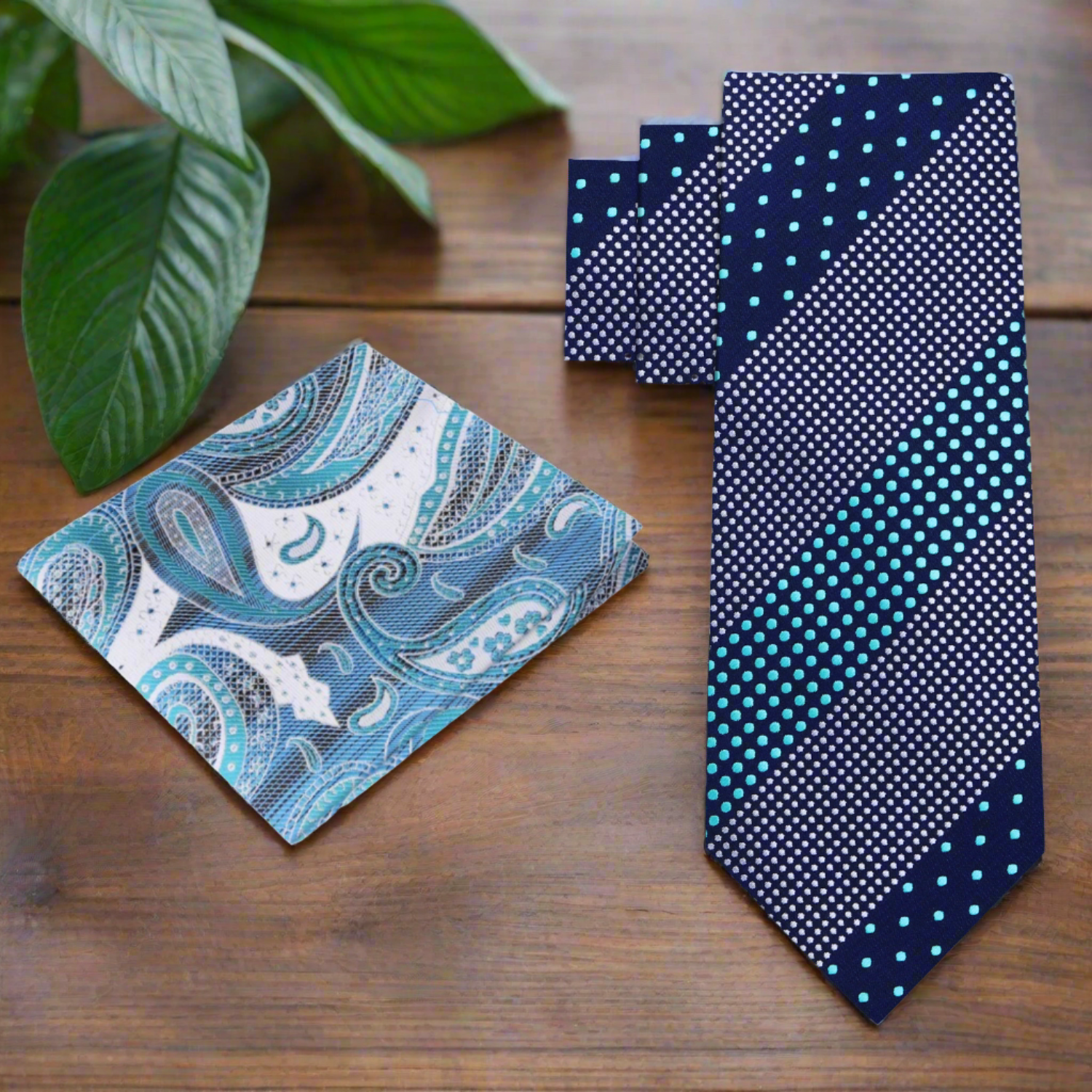 Silk polka dot tie laid flat against a white background showing the full pattern and dark blue tones
