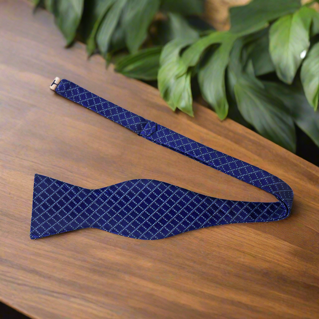 Close-up of the fabric and pattern of the best checkered bow tie for men in deep red and blue tones