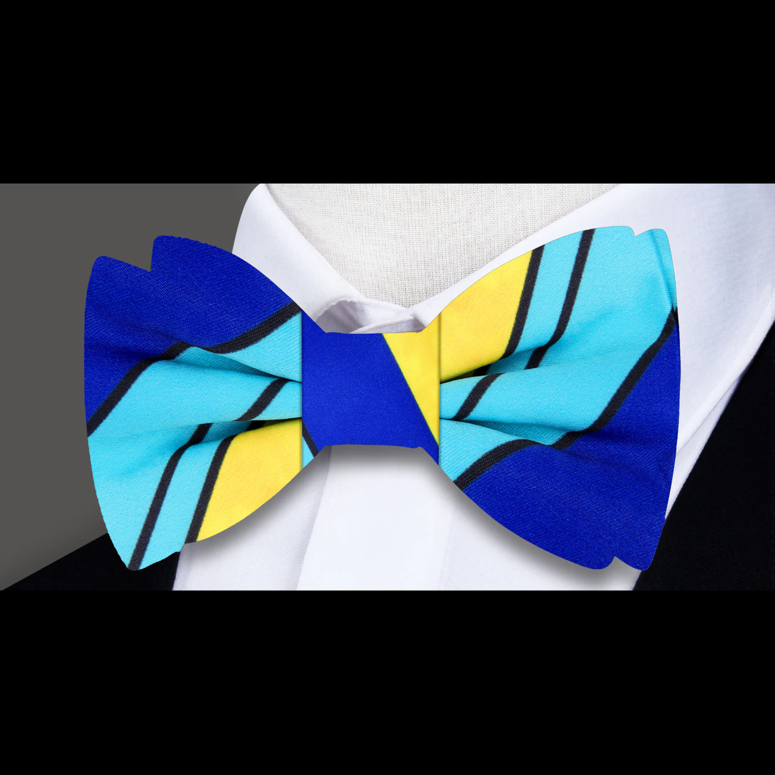 Model wearing the blue and yellow stripe bow tie at a summer wedding, exuding confidence and style.