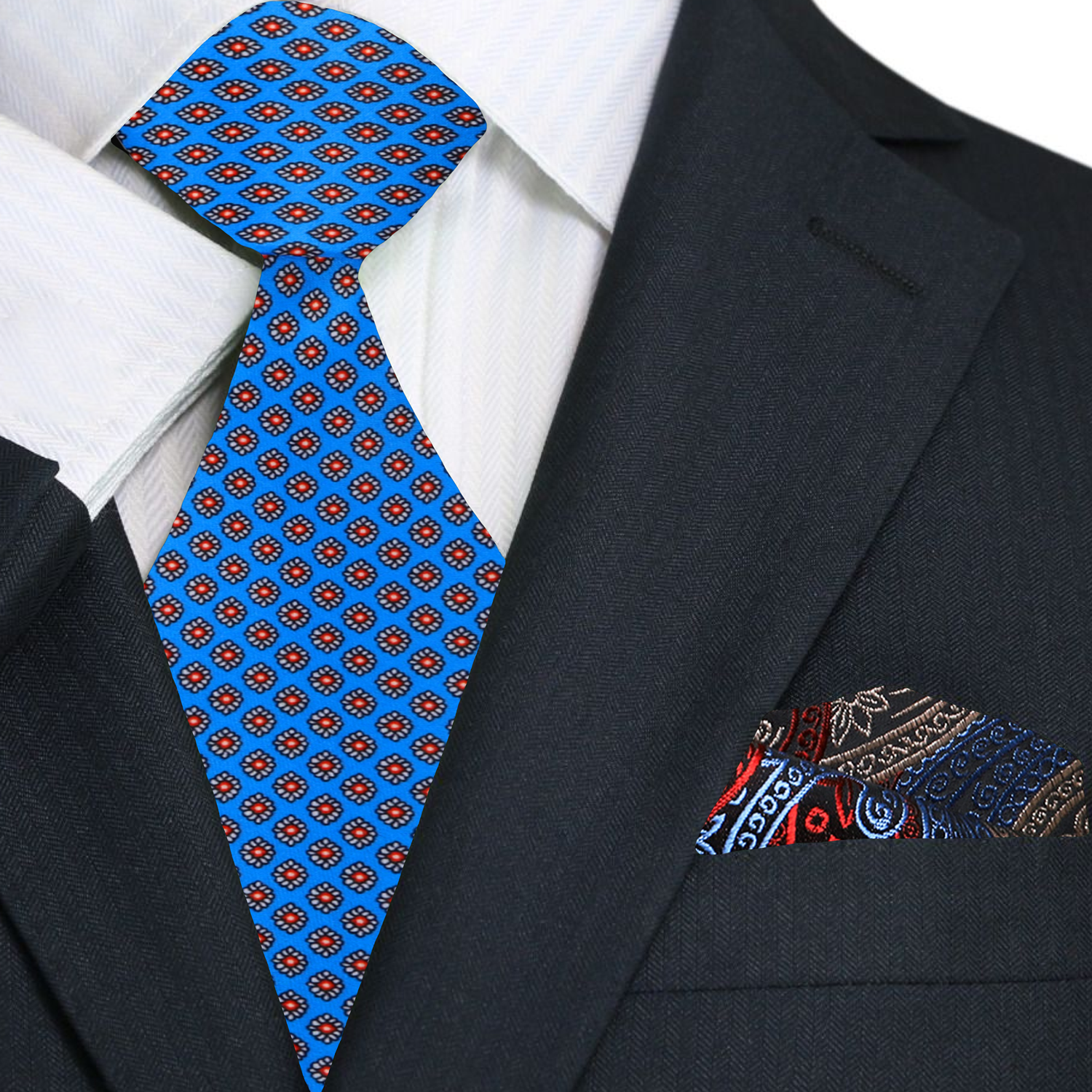 Model wearing the blue silk necktie with red medallions paired with a white dress shirt and navy suit