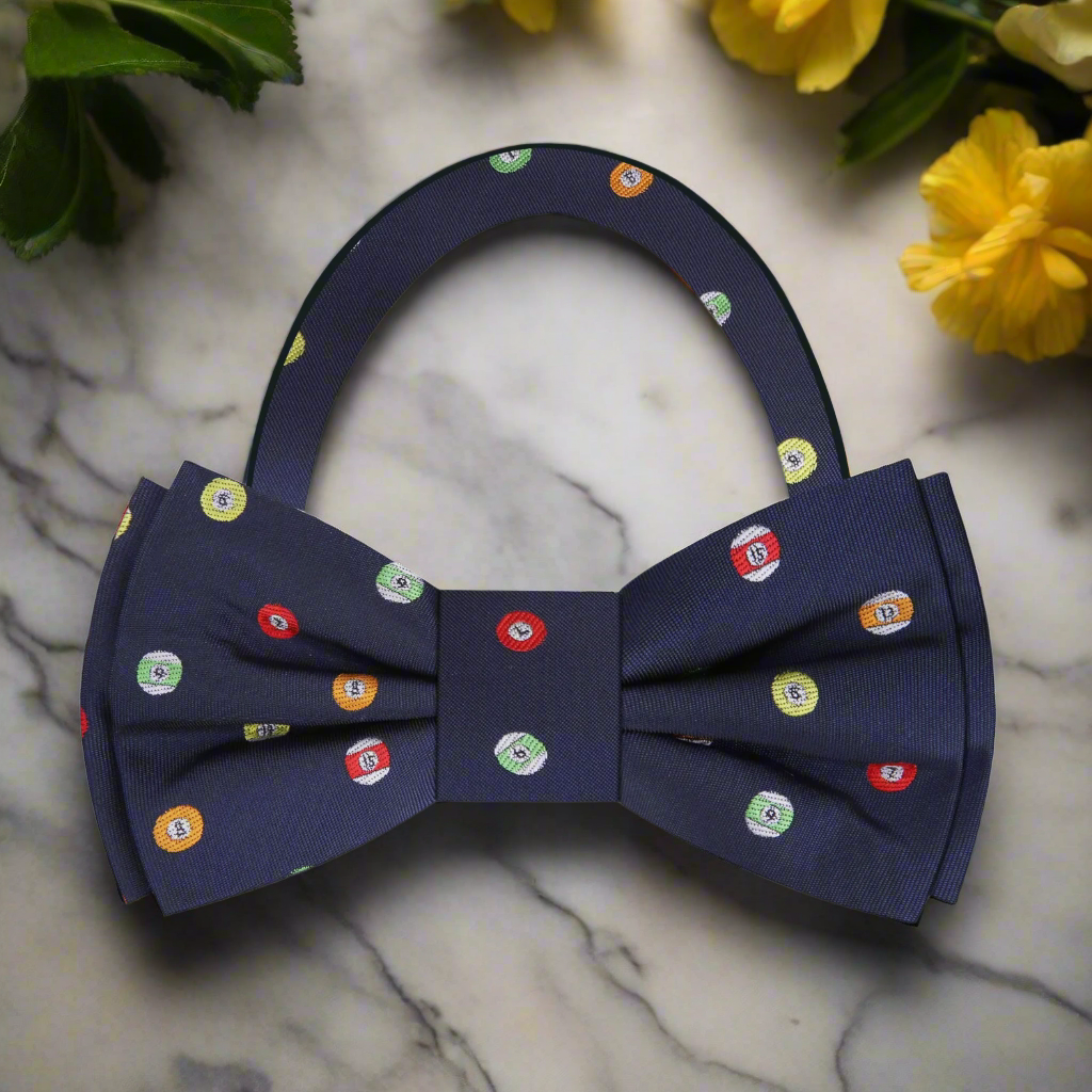 Front view of the Rack & Roll billiards bow tie showing multicolored balls on dark blue silk