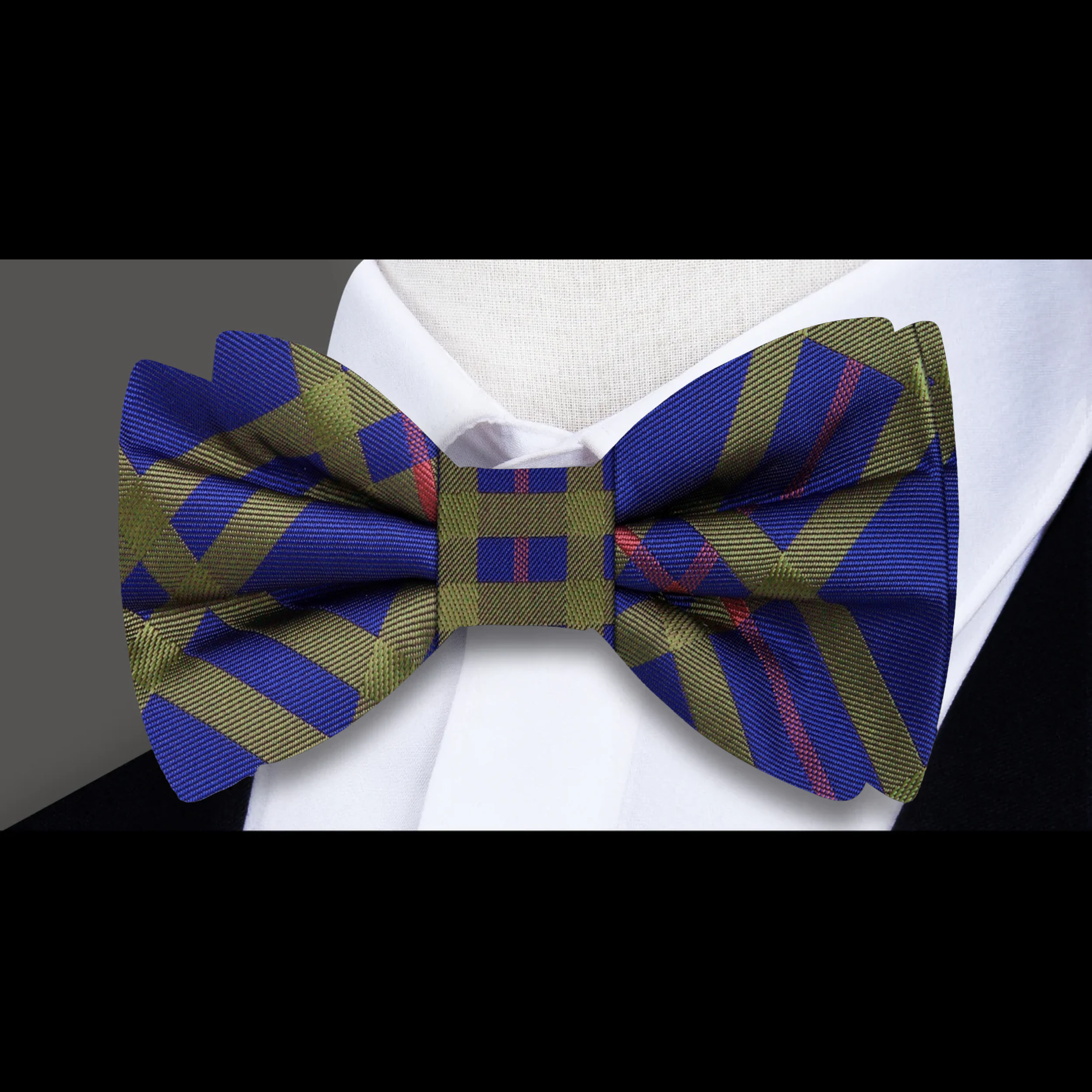 Man adjusting a plaid silk bow tie at a wedding