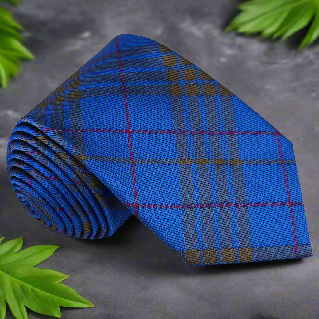 Close-up of the plaid silk tie showcasing the rich blue, olive green, and red tones.