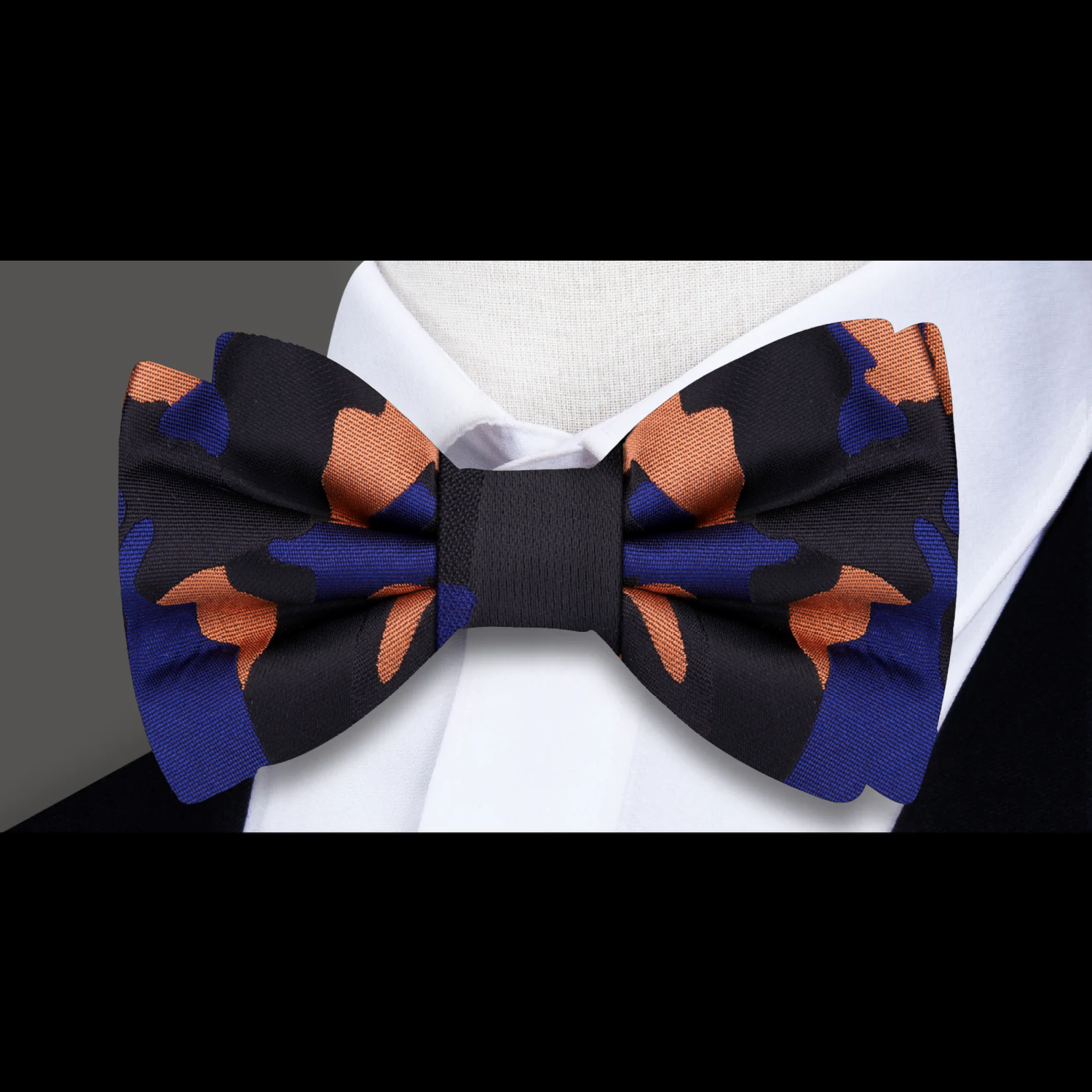 Man adjusting self-tie camouflage bow tie for a formal event