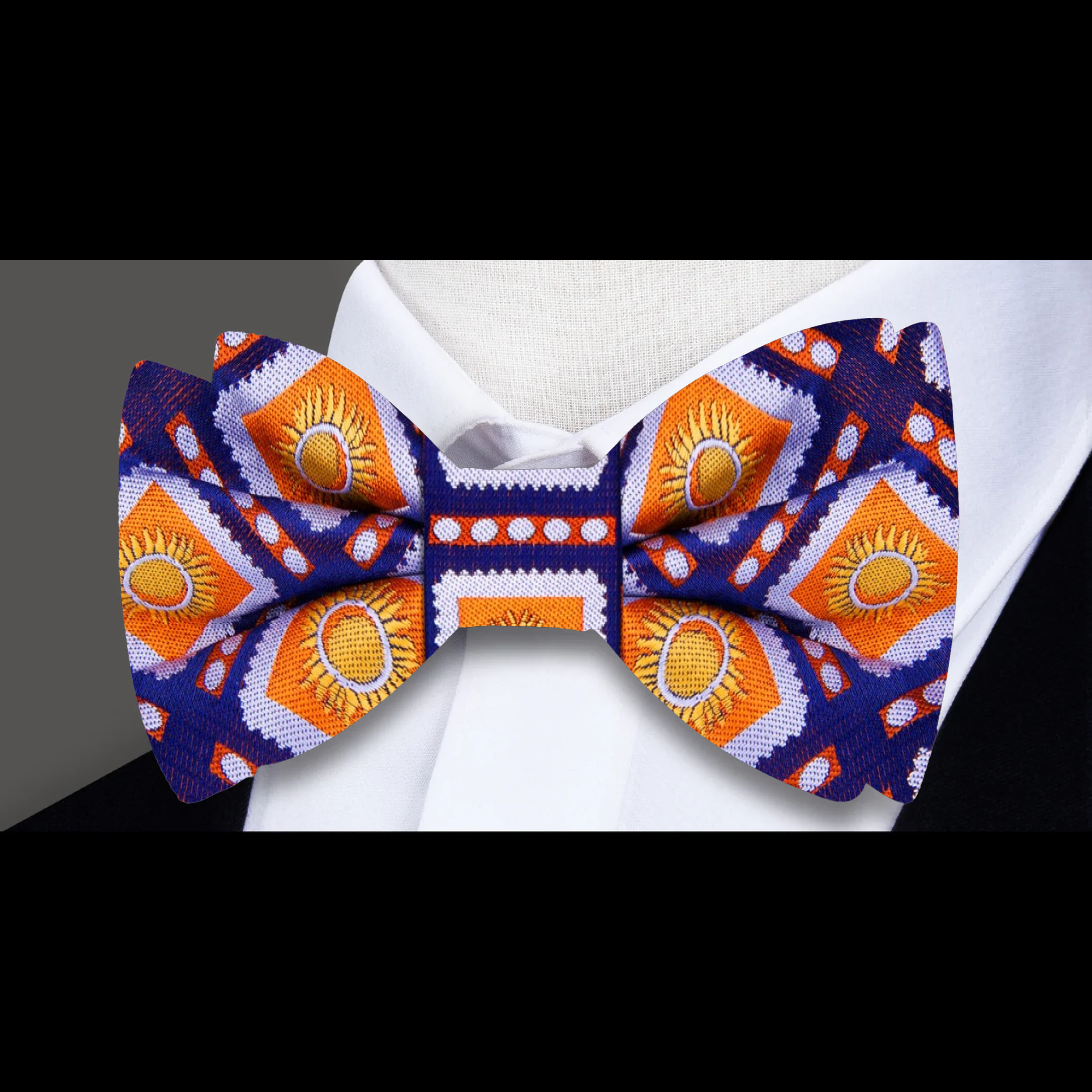 Fashion accessory – silk bow tie in dark blue and orange with sunburst pattern, ideal for formal occasions