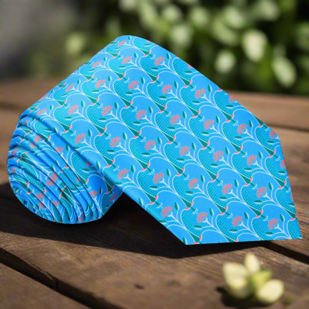 Light blue necktie featuring orange and green apple slice pattern, ideal for summer weddings.