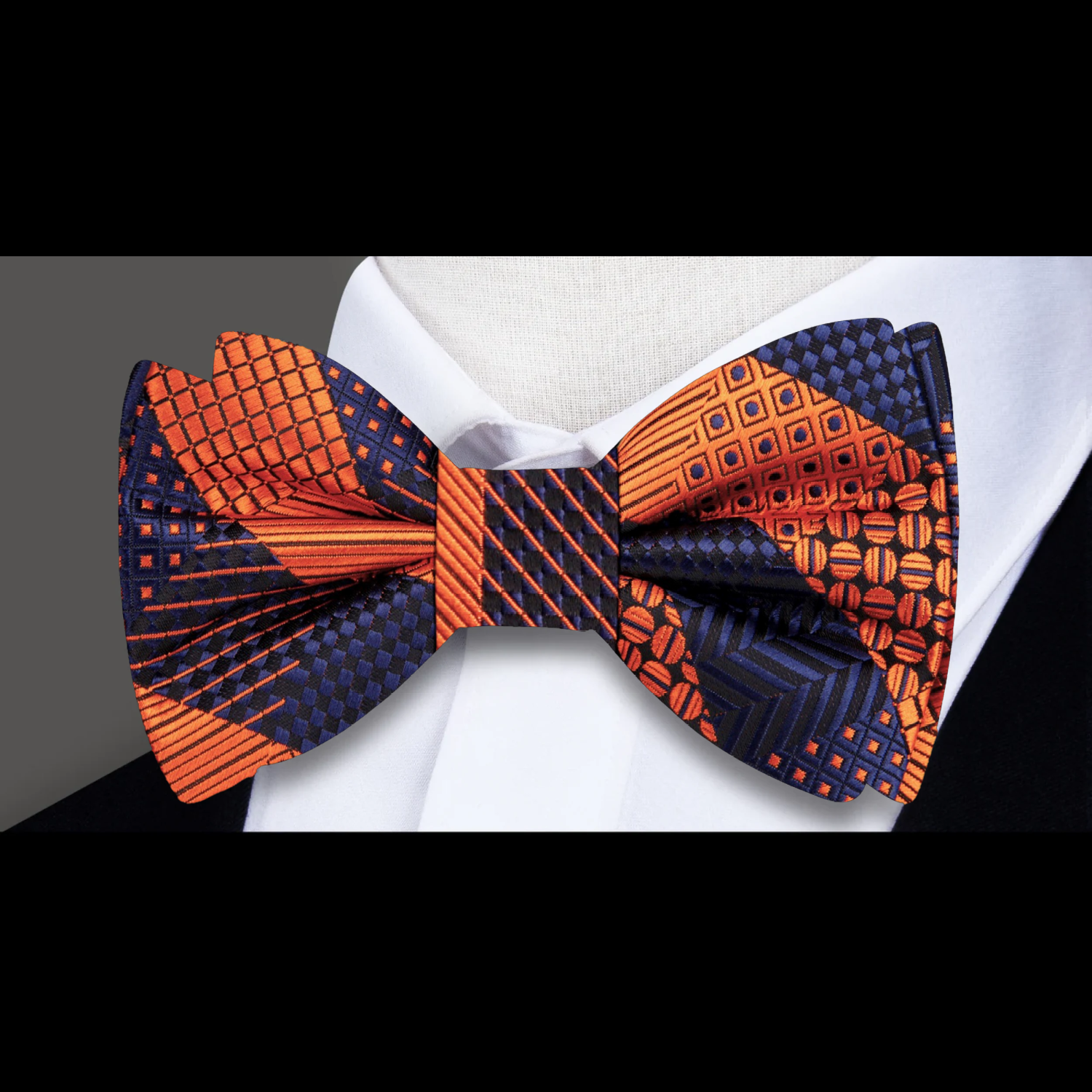 Chic grey plaid self-tie bow tie paired with a charcoal grey suit, demonstrating a formal look.