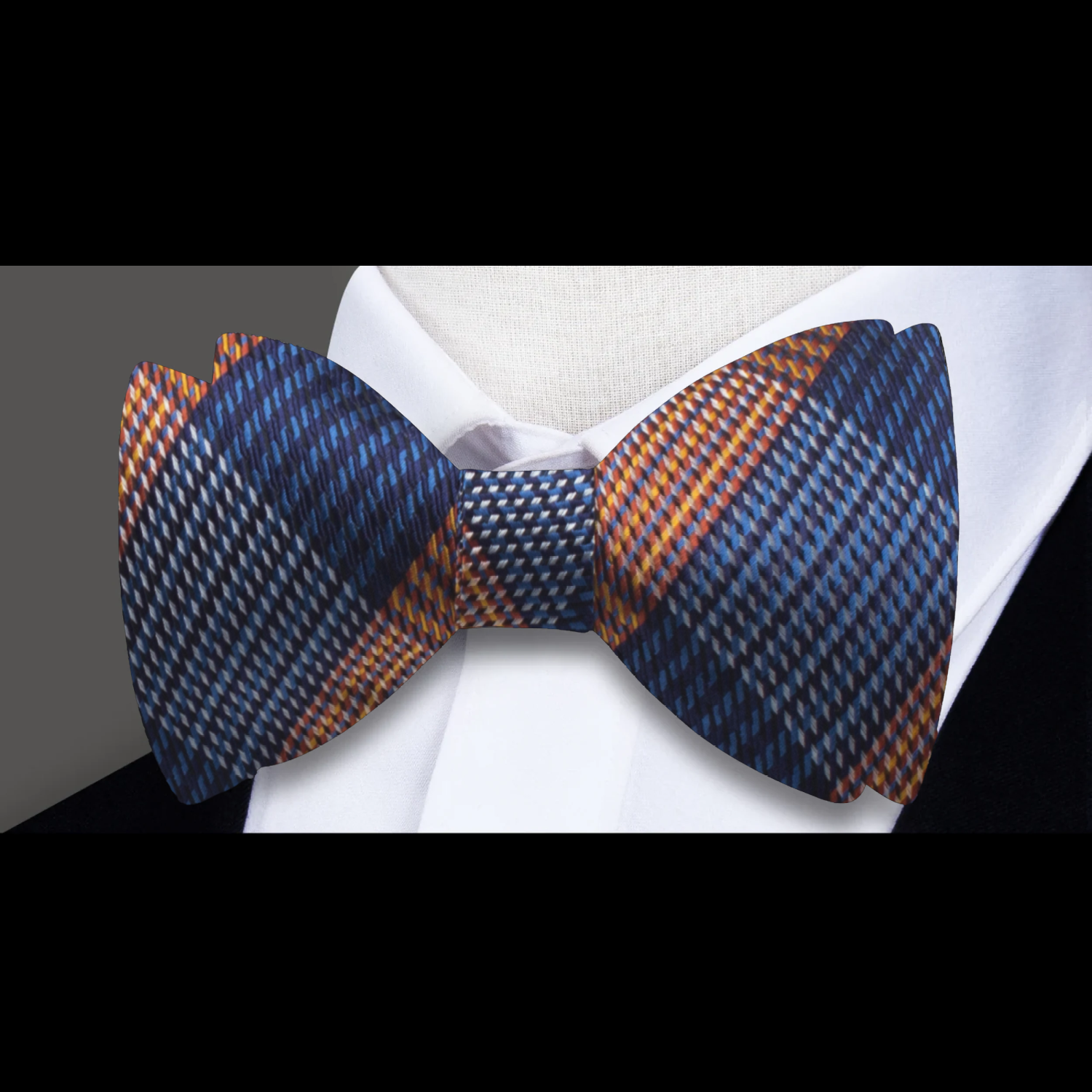 Front view of silk plaid bow tie styled with a dress shirt and suit