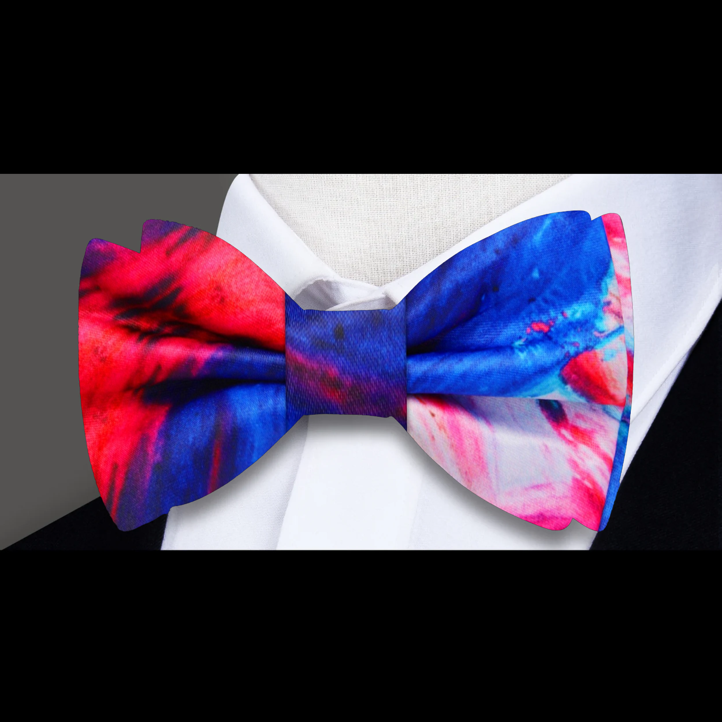 Model wearing a blue and pink watercolor silk bow tie paired with a crisp white dress shirt for a formal look.