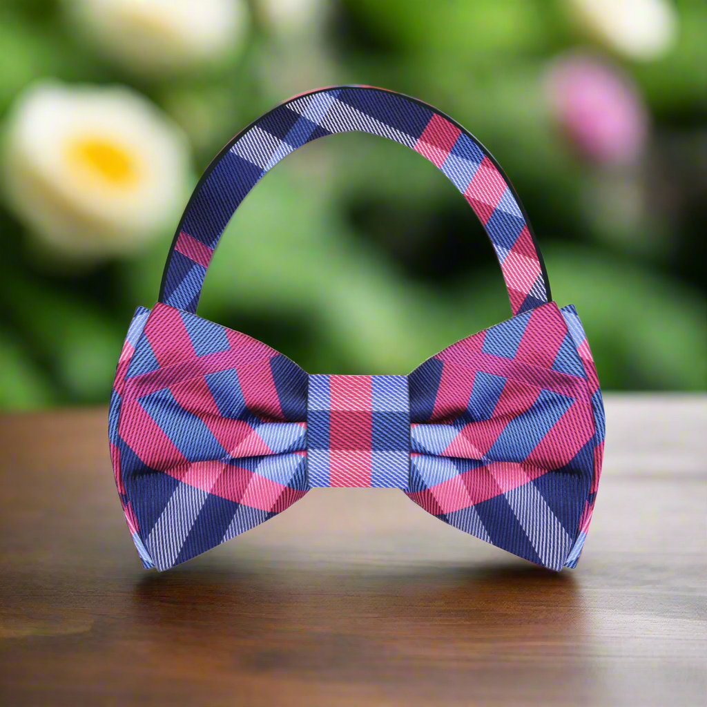 Grey plaid bow tie styled with a light grey suit, ideal for business meetings.