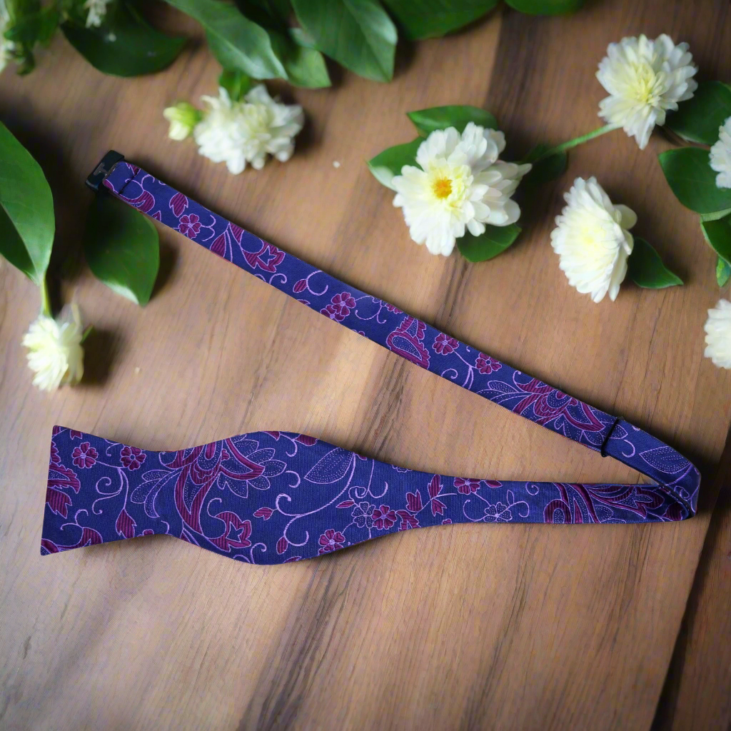 Elegant paisley silk bow tie in white on models neck for formal occasion