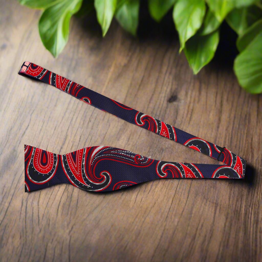 Model wearing the dark blue paisley self-tie bow tie at a wedding, exuding elegance and style.