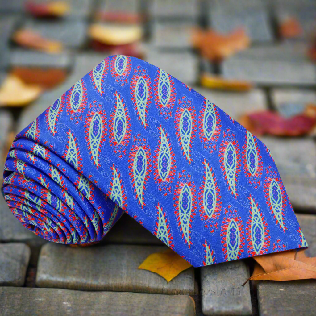 Close-up of the blue paisley silk necktie showcasing vibrant motifs.