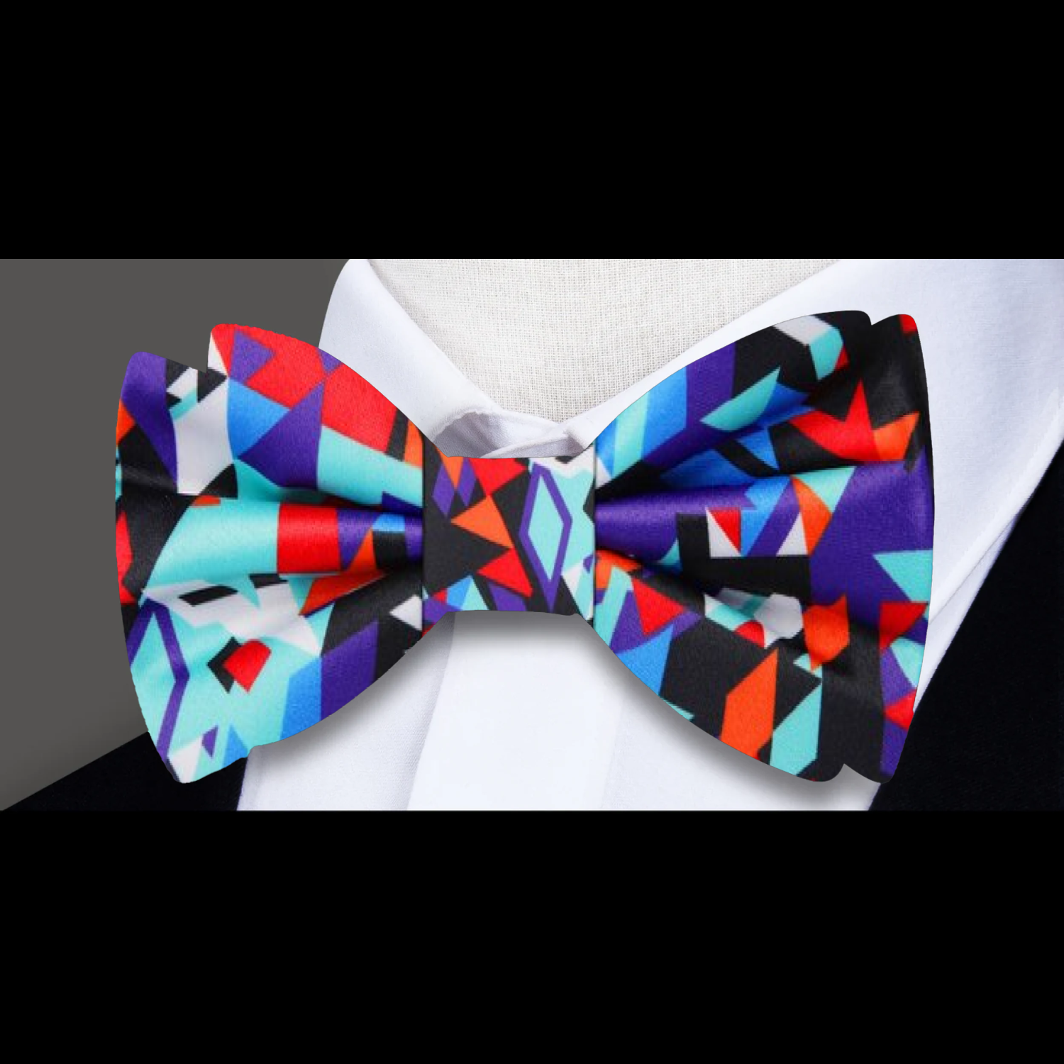 Man adjusting his pre-tied silk bow tie in a formal setting