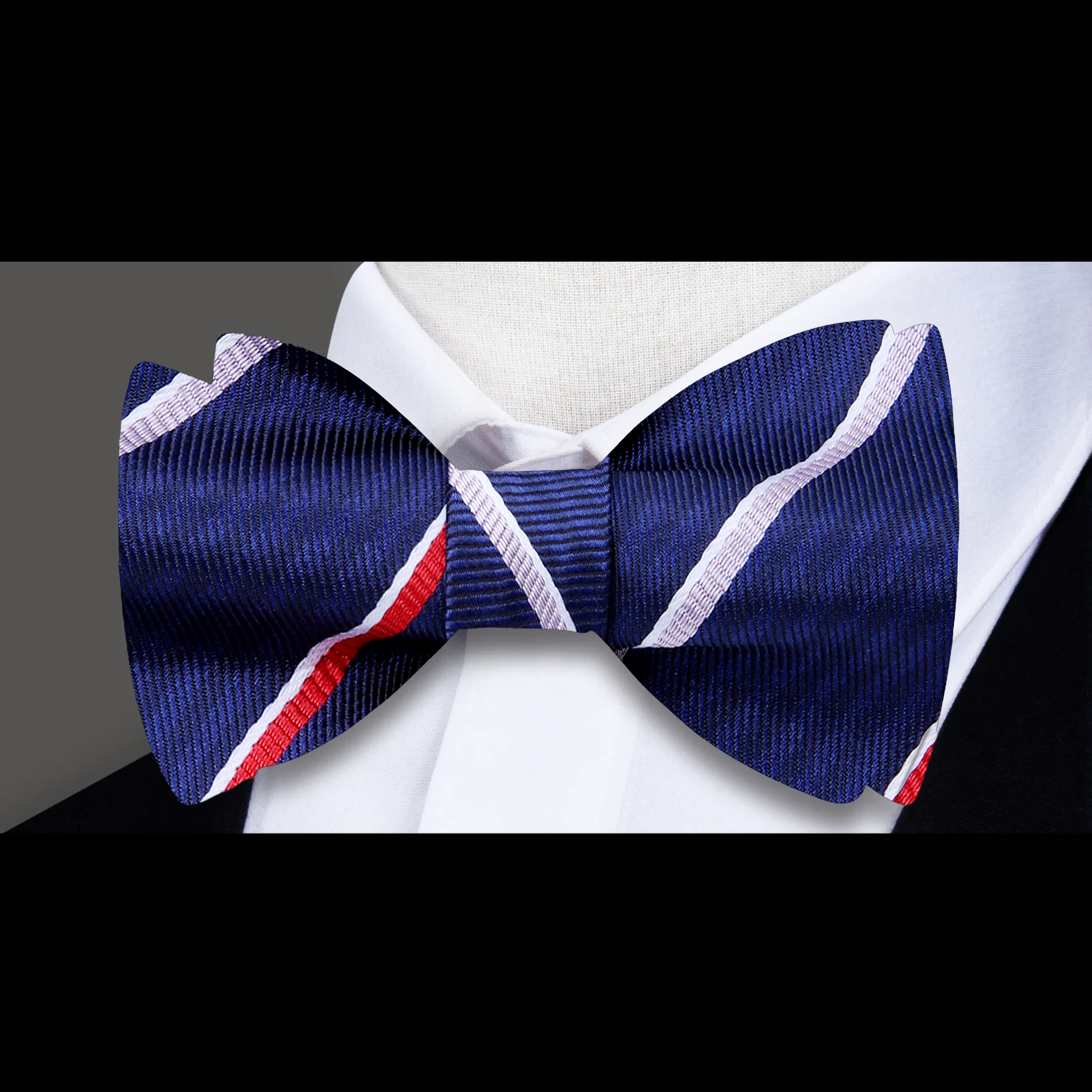 Styled outfit featuring a silk bow tie paired with a navy suit for formal event