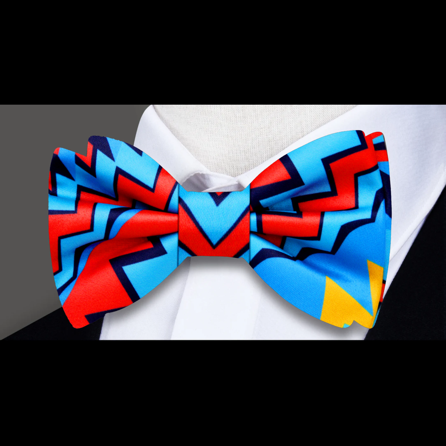 Vibrant abstract silk bow tie showcasing bright colors and geometric design for cultural events.
