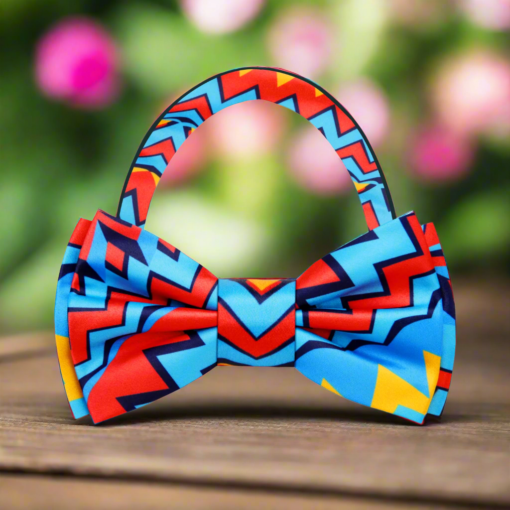 Model wearing the vibrant abstract silk bow tie with a navy suit, perfect for weddings.
