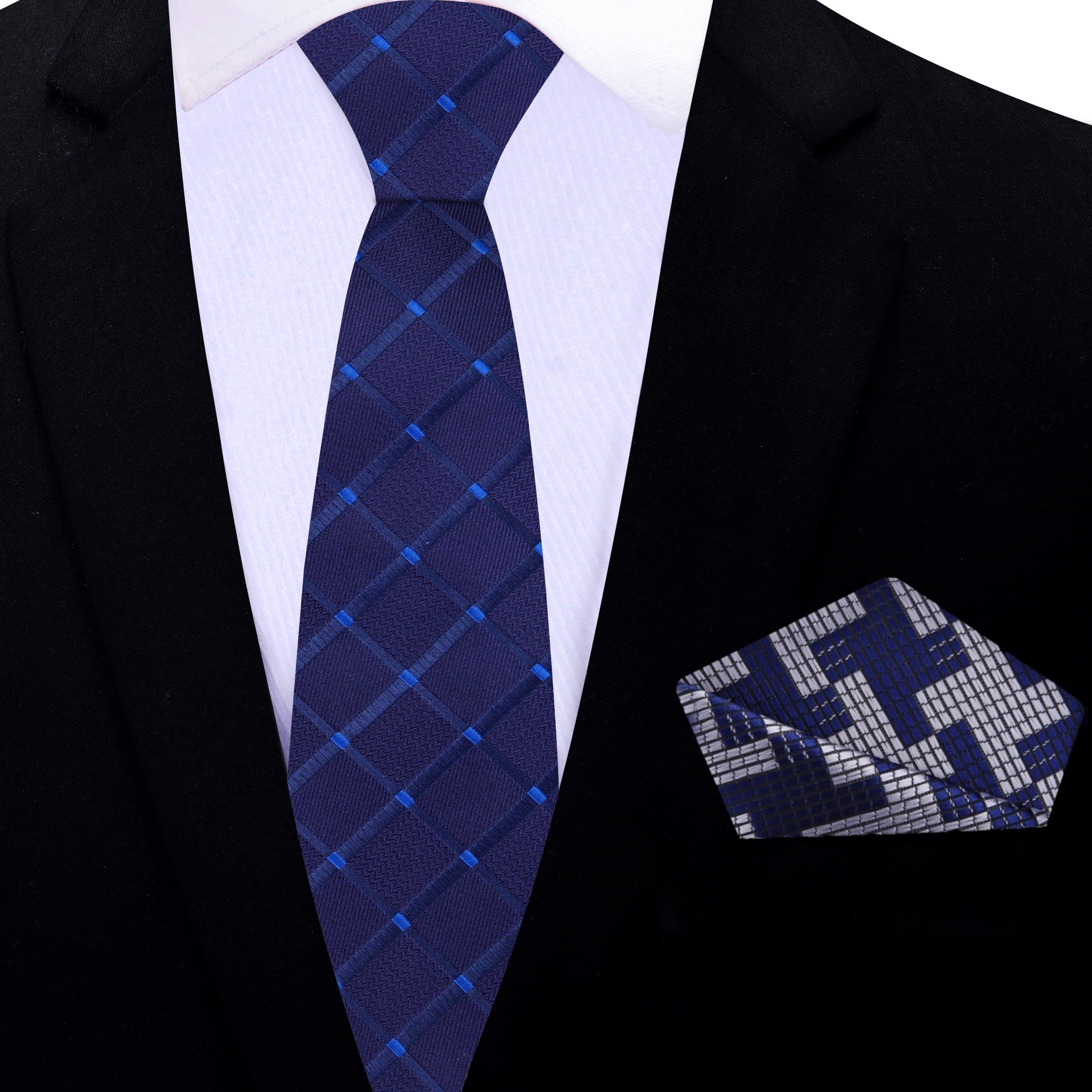 Close-up of the geometric pattern on the mens dark blue necktie
