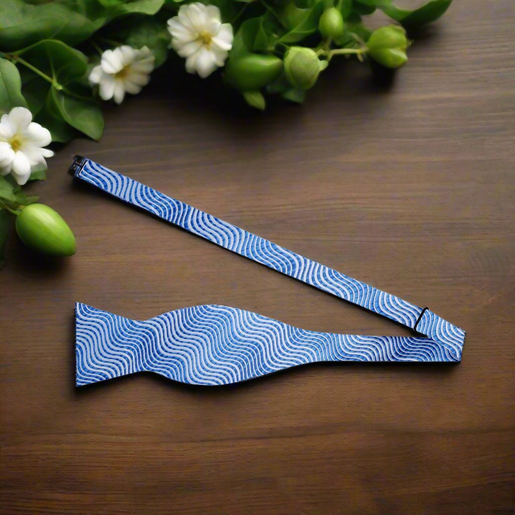 Azure Waves bow tie displayed with matching pocket square, ideal for weddings or cocktail parties.