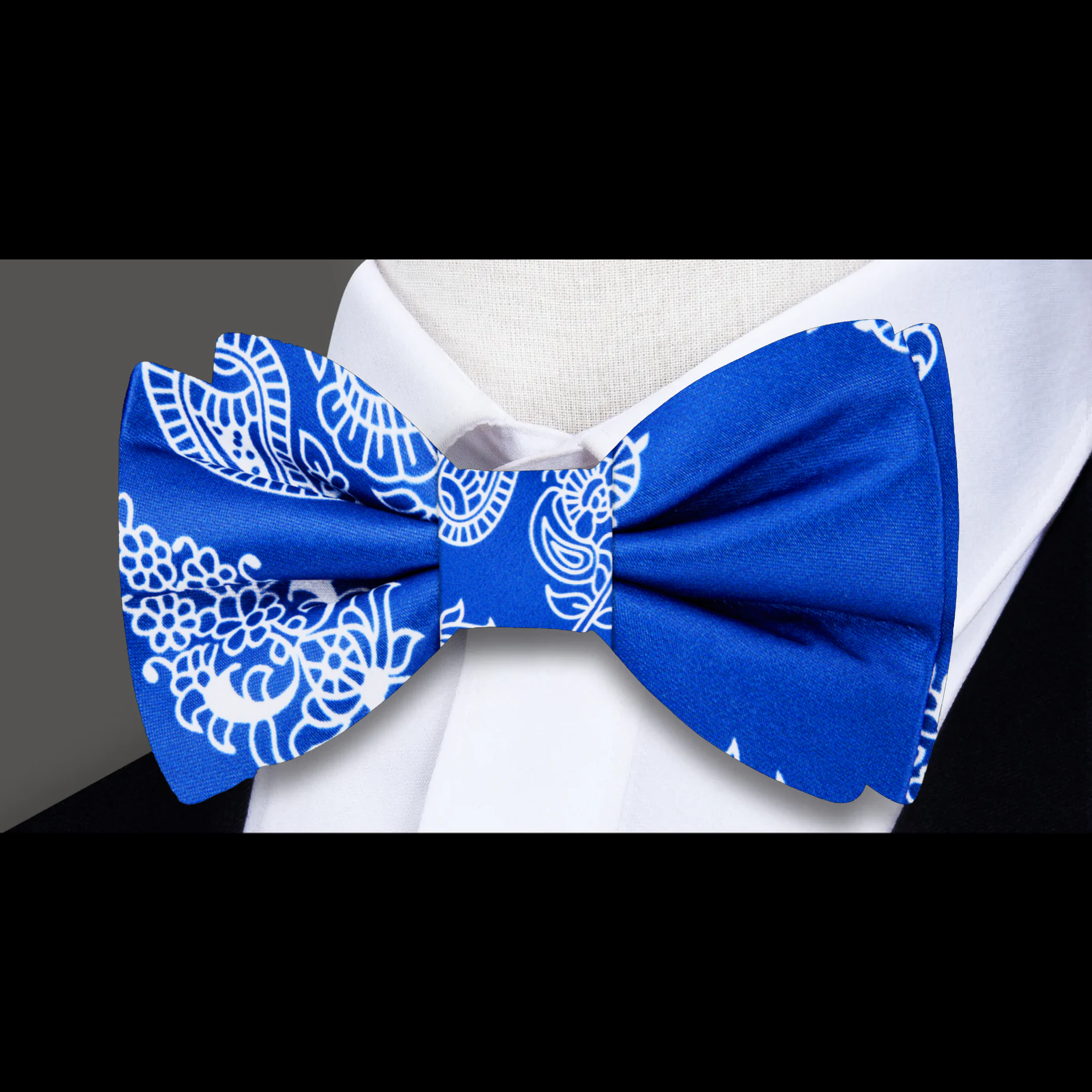 Model wearing a silk paisley bow tie with a white dress shirt for a western wedding