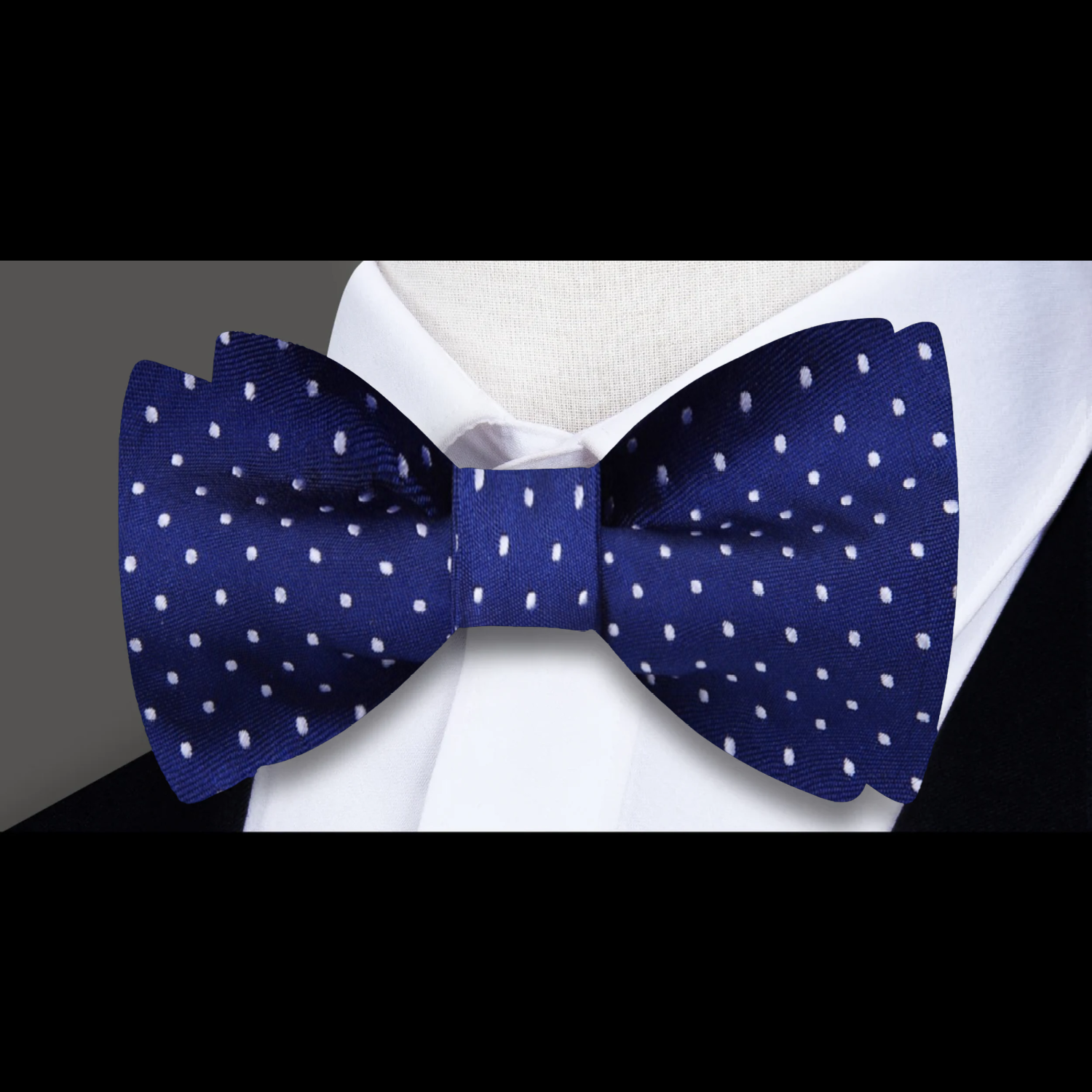 Green microdot silk bow tie styled with a white pinpoint oxford shirt for a classic look.